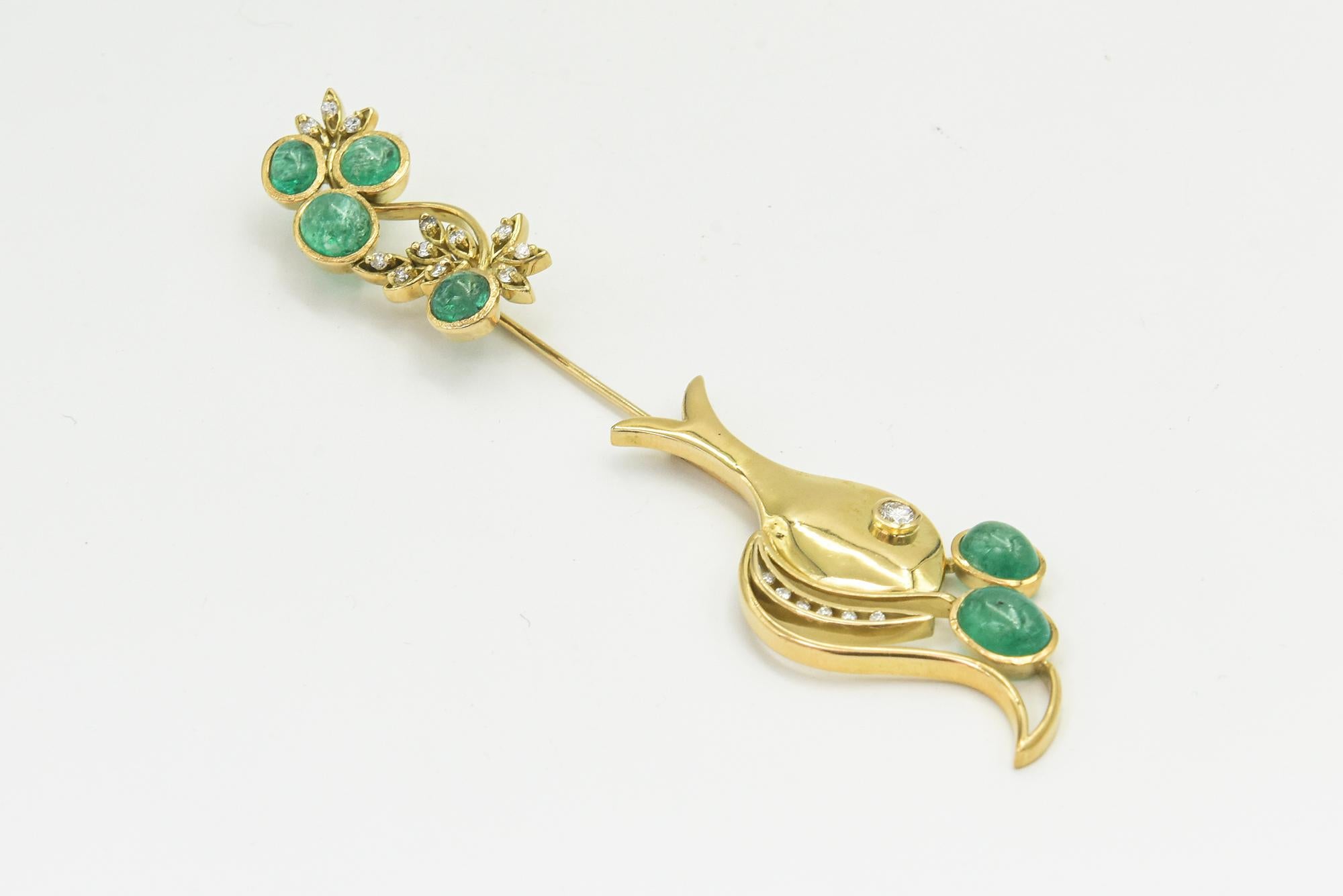 This jabot pin was a custom made in the 1970s,  it uses the jabot style to illustrate a fish swimming through the sea.  The 18k yellow gold fish brooch is accented with diamonds and emeralds.  To open you just pull at either end.

According to