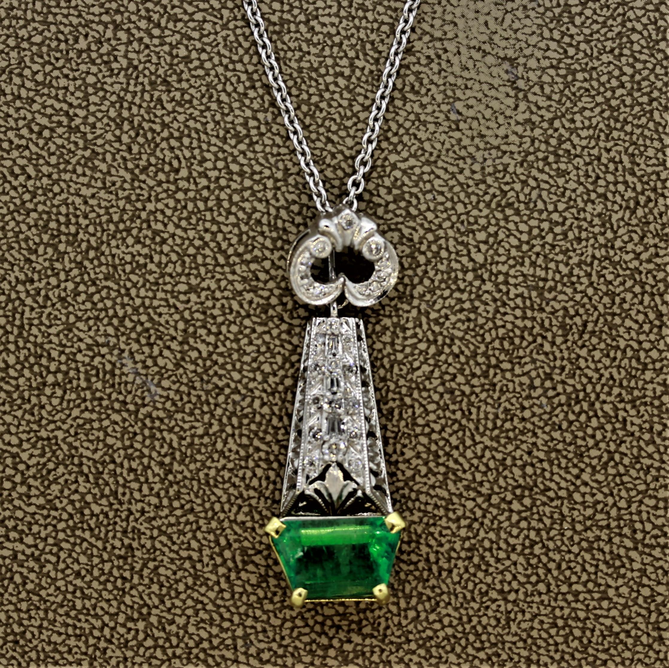 A unique pendant with a uniquely shaped emerald! The emerald weighs 3.73 carats and is cut as a trapezoid. It has a sweet green color typical of Colombian emeralds. It is accented by 0.40 carats of diamonds set above the emerald. Made in 18k