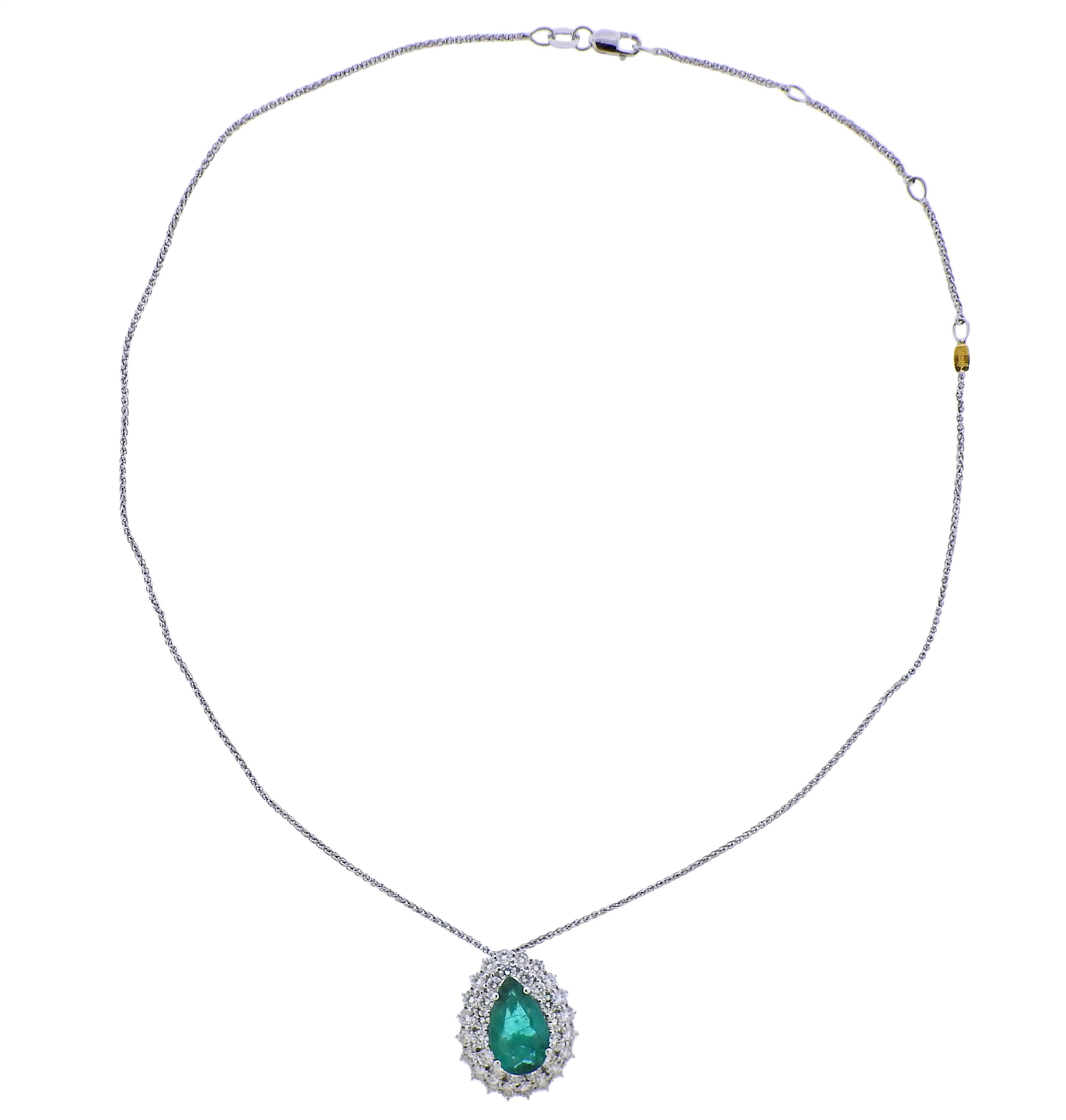 18k white gold chain with suspended pendant. Featuring pear shape emerald (approx. 13.2 x 8.5 x 4.3mm)  surrounded with approx. 1.60ctw in diamonds. Necklace is 17