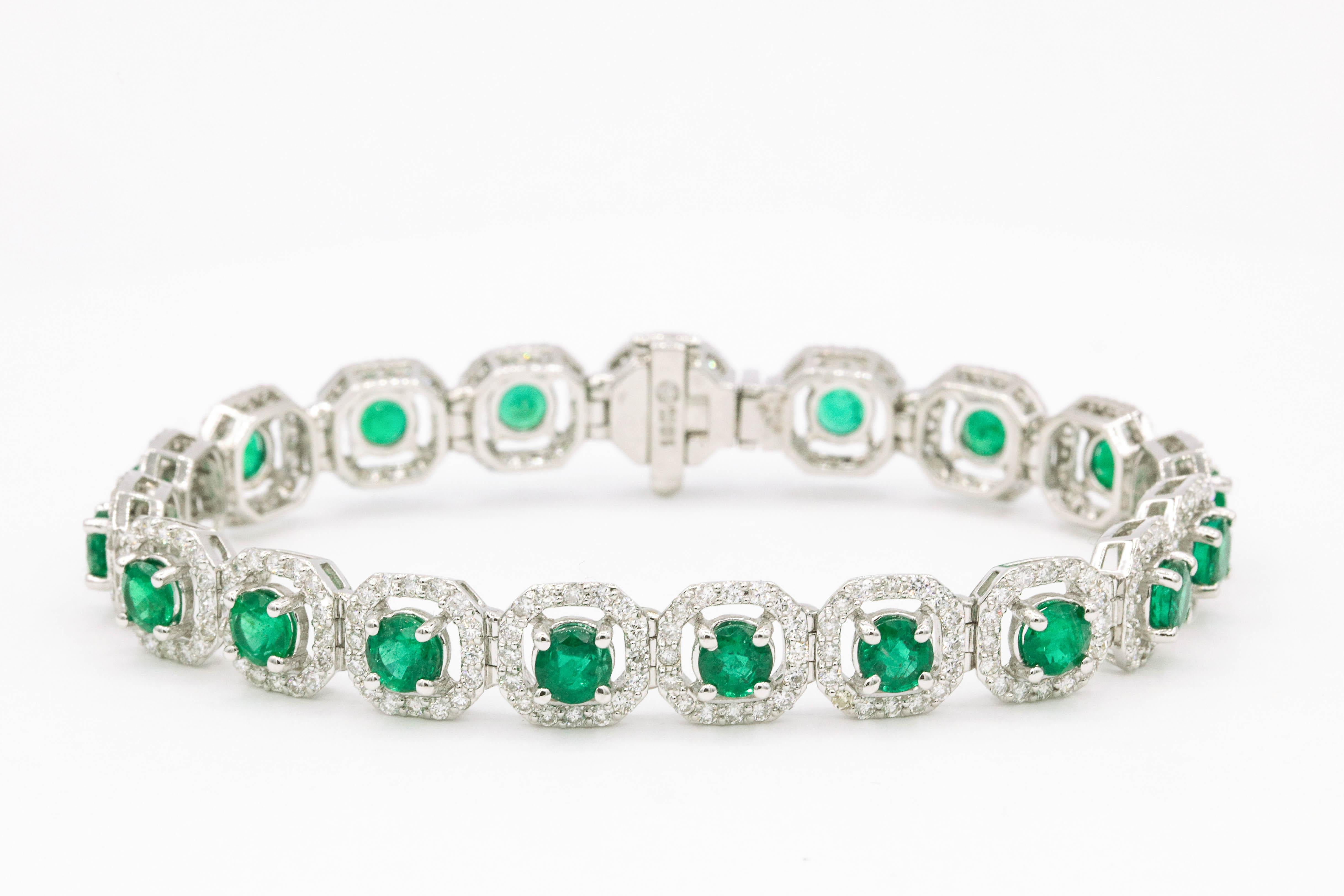 Nineteen round green emeralds, 7.02 carats, flanked with 304 round brilliants weighing 3.50 carats, in 18k white gold. 