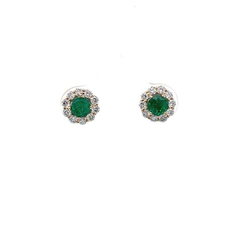 This pair of earrings are made of round green emerald with a total carat weight of 0.57 carats, selected for their color and brilliance. The green emeralds are set in a yellow gold setting 18-carat weight, accented with a single row of round white