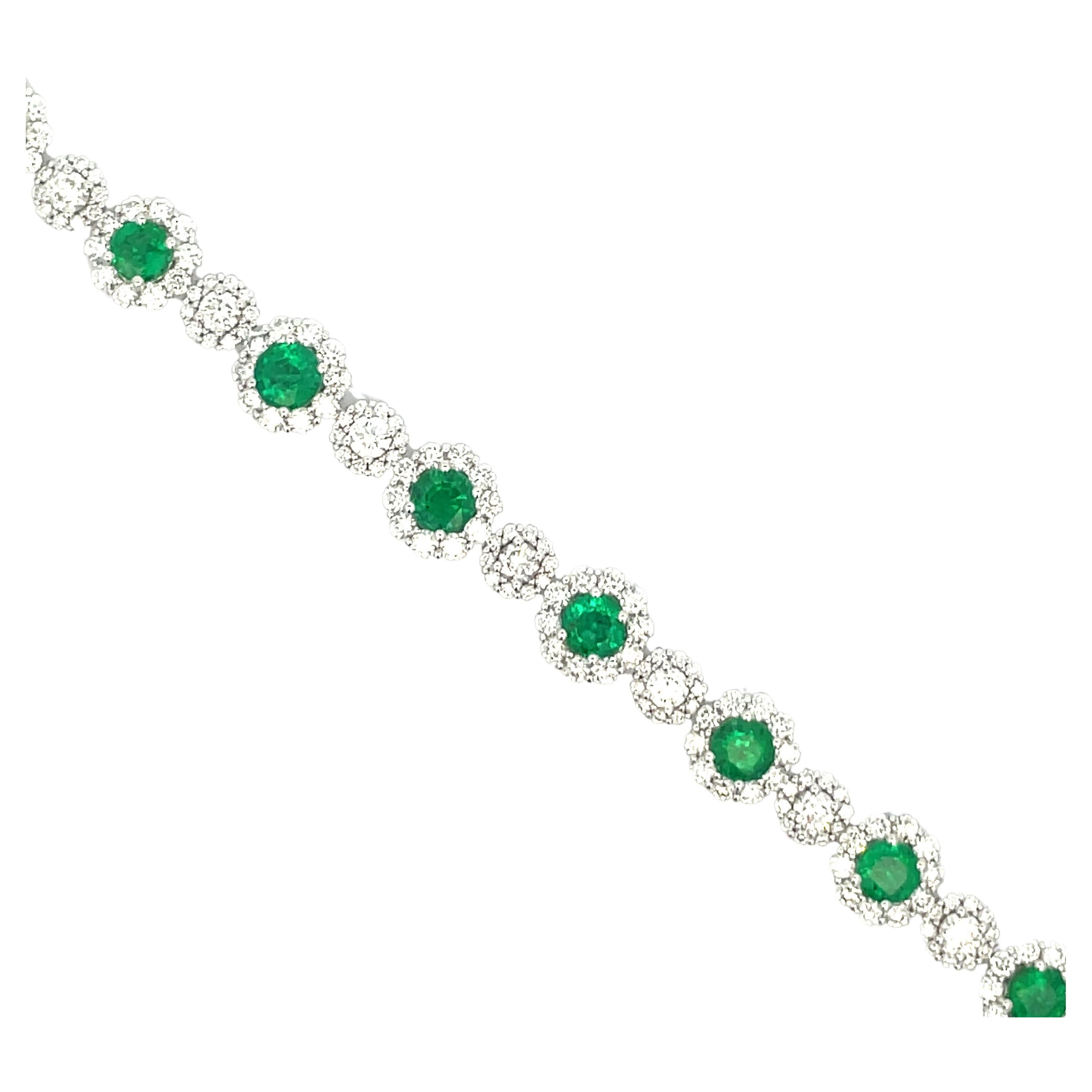 Alternating Emerald and Diamond link bracelet containing 12 Emeralds weighing 5.48 Carats and 254 round brilliants weighing 5.48 carats, in 18 karat white gold. 
Color G-H
Clarity SI