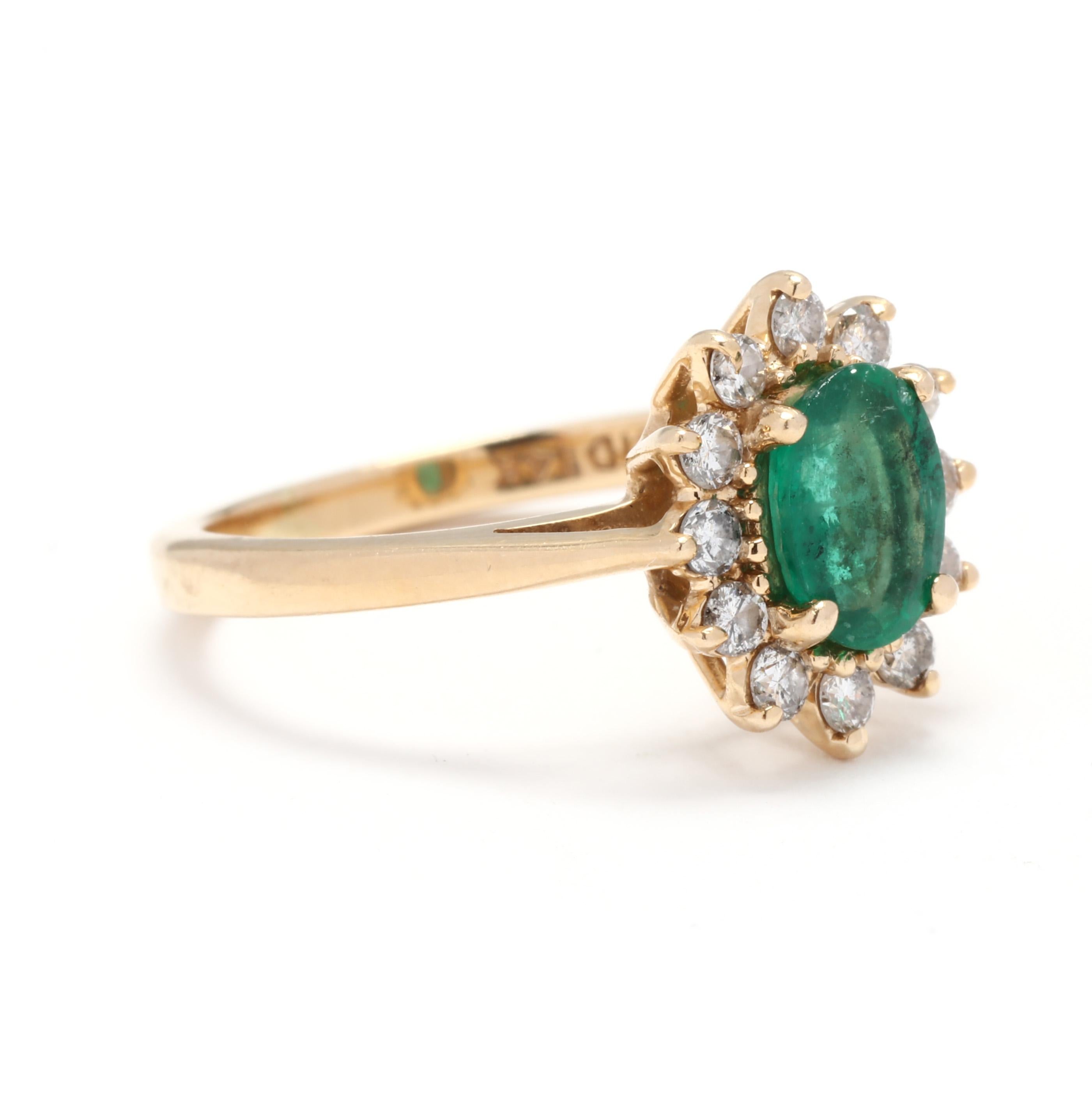 A vintage 14 karat yellow gold emerald and diamond halo ring. This right hand ring features a prong set, oval cut emerald weighing approximately .80 carat surrounded by a halo of round brilliant cut diamonds weighing approximately .25 total carats