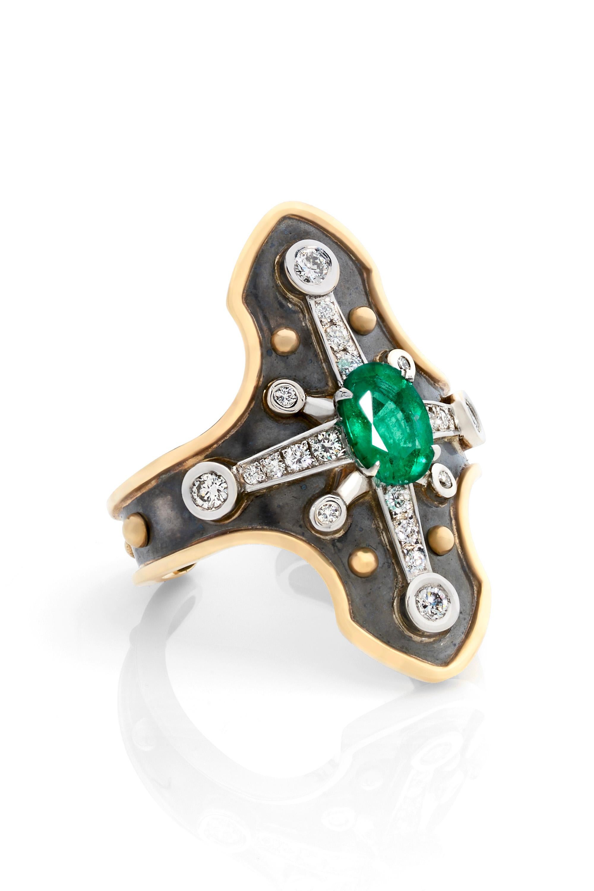 Yellow gold and distressed silver ring studded with an oval emerald surrounded by diamonds and set on a white gold star.

Details:
Emerald: 7x5x 0.8 cts
22 Diamonds : 0.33 cts    
18k Gold : 4.5 g 
Distressed Silver: 3 g
Made in France