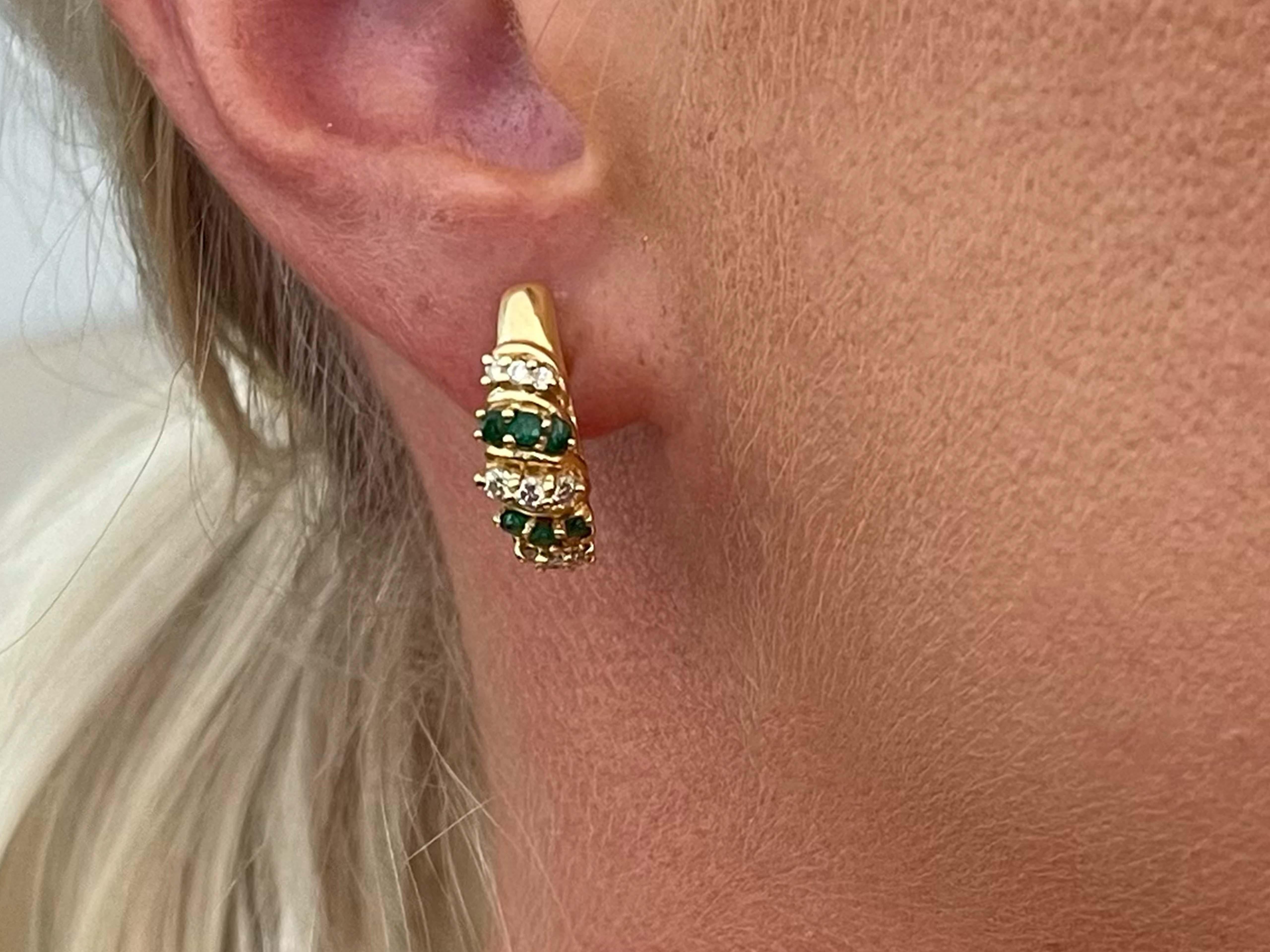 Earrings Specifications:

Metal: 14k Yellow Gold

Earring Diameter: 20.43 mm x 18.55 mm

Total Weight: 7.3 Grams

Emeralds: 6

Emerald Carat Weight: 0.40 carats

Diamonds: 18

Setting: Prong

Diamond Color: G

Diamond Clarity: SI1

Diamond Carat