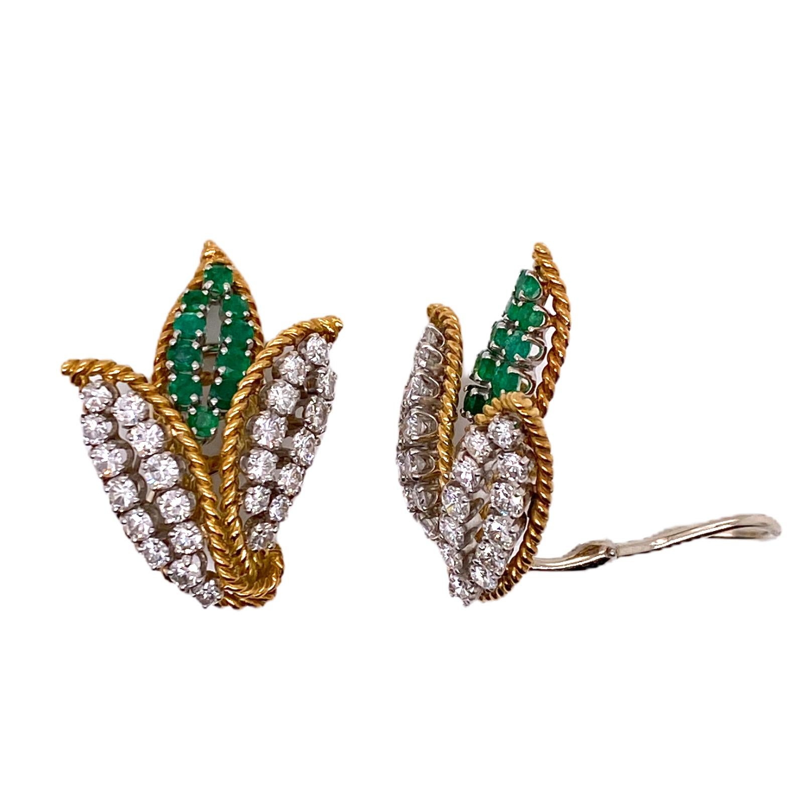 Gorgeous diamond emerald leaf motif earrings fashioned in 18 karat yellow gold and platinum. The earrings feature 50 round brilliant cut diamonds weighing 3.00 carat total weight and graded F-G color and VS clarity. The center leaf is set with 20