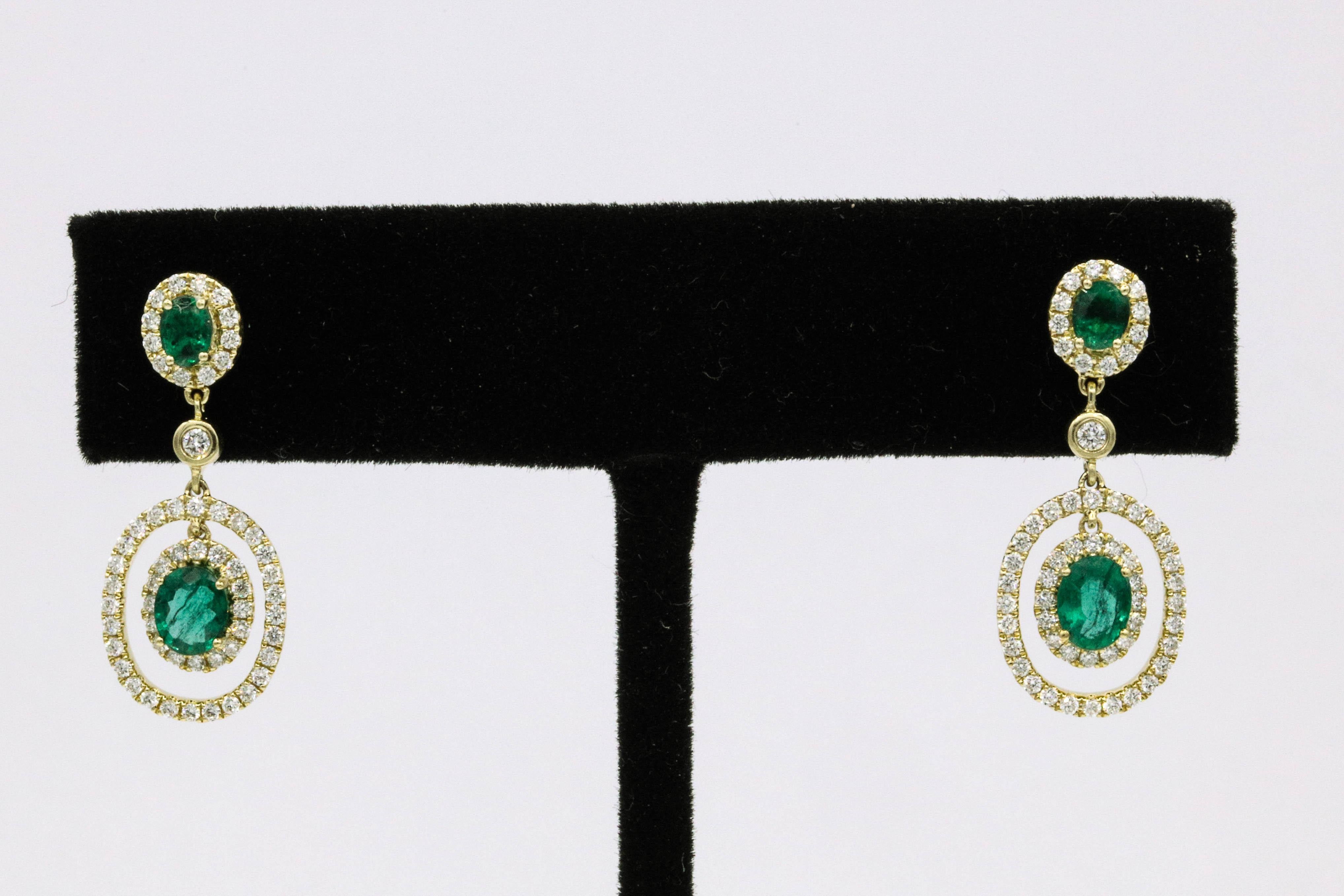 14K Yellow gold drop earrings featuring four green emeralds, 1.14 carats, surrounded by round brilliants weighing 0.65 carats.
Color G-H
Clarity SI
