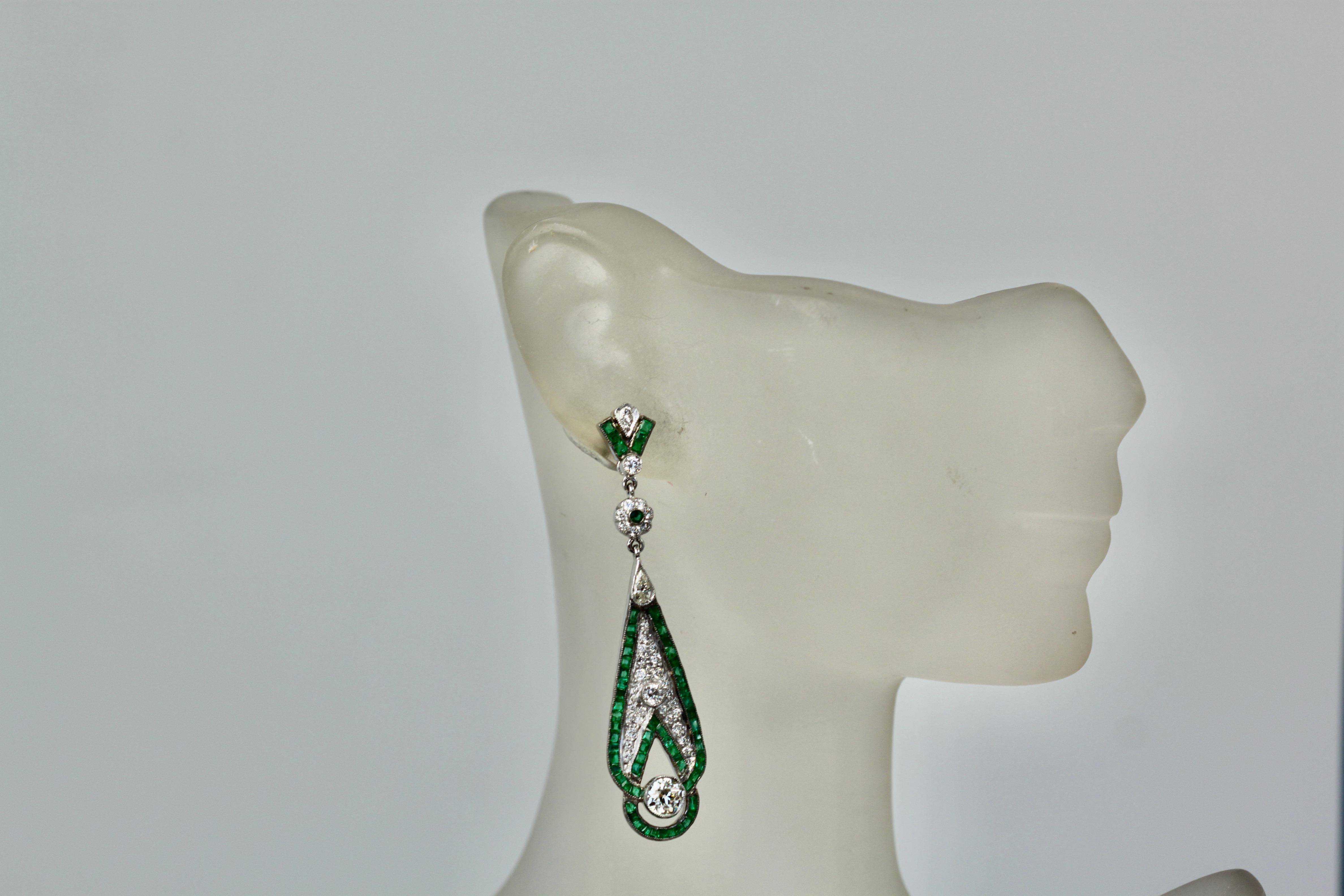 These gorgeous Emerald Diamond Pendant earrings are from France and they are lovely. These pendant earrings weight 13.9 grams and they are 5cm long x 14 mm wide.  The top has 6 baguette Emeralds, 2 small Diamonds, a Diamond flower with Emerald