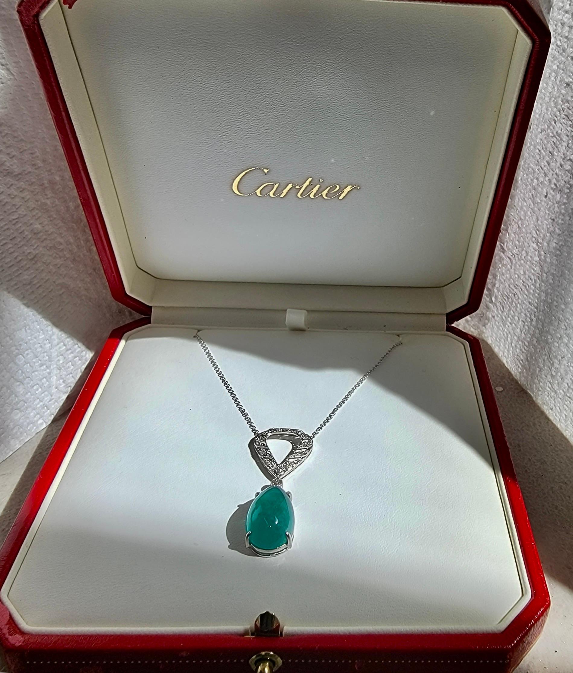 his vintage 1950s large emerald & diamond pendant was a family heirloom. A stunning deep green emerald is prong set within a platinum setting. The pendant & small diamond link are suspended & dangle from an elegant understated ovoid shape diamond
