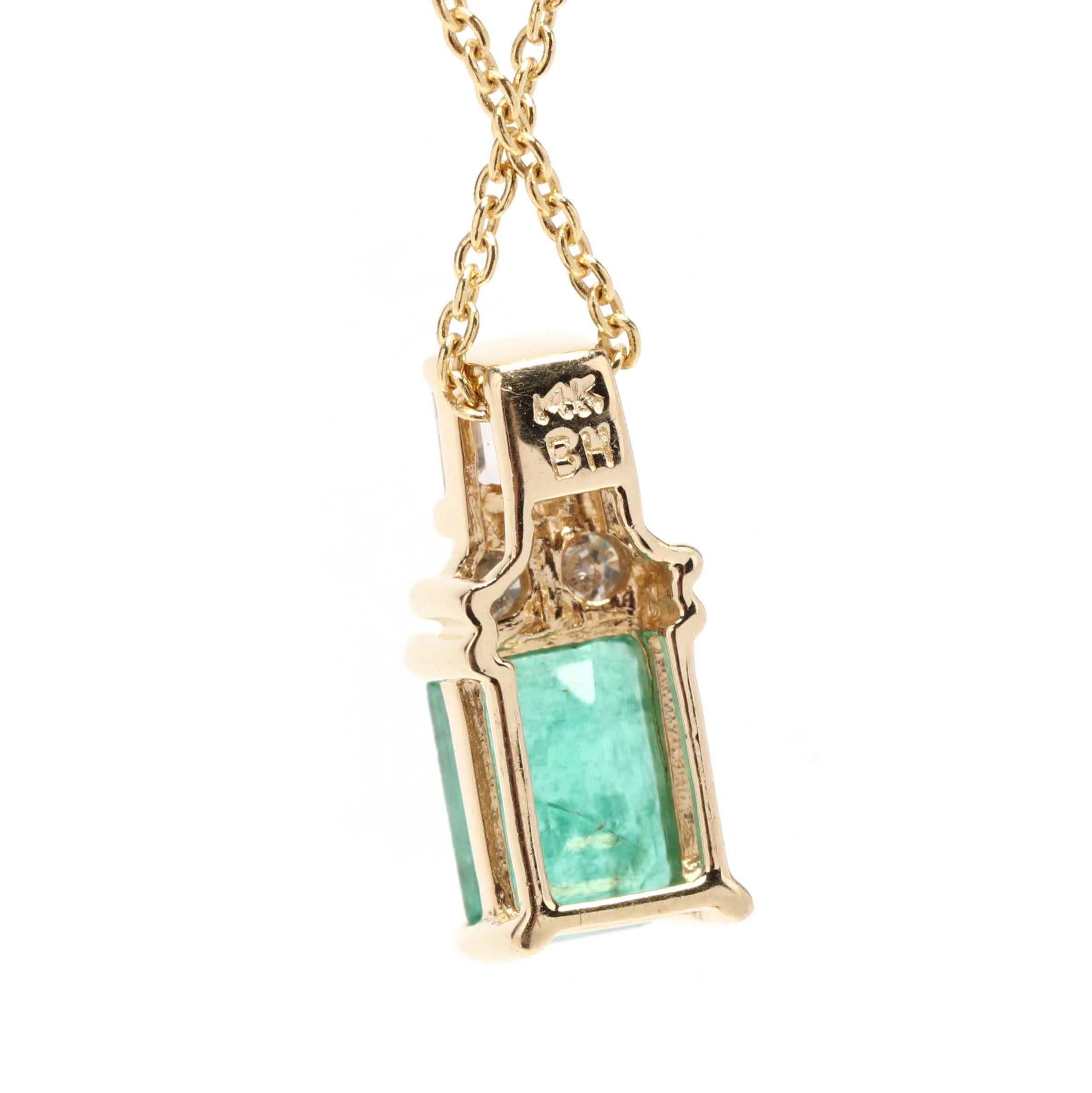 A vintage 14 karat yellow gold emerald and diamond pendant necklace. This May birthstone necklace features a prong set, emerald cut emerald weighing approximately 1 carat with a cluster of baguette and round brilliant cut diamonds set above weighing