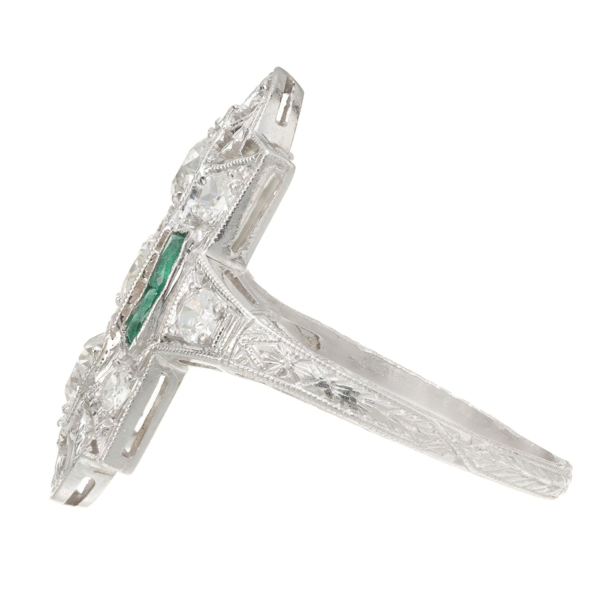 Original 1920’s diamond and emerald pierced and engraved Art Deco Platinum ring. Set with 4 genuine Emeralds and 9 European full cut diamonds. Slight chip to the corner of one emerald.

3 round old European cut diamonds approx. total weight .45cts,