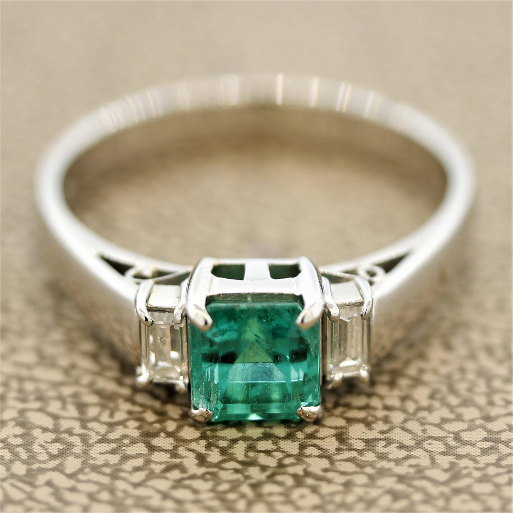A classic 3-stone ring featuring a gemmy 0.89 carat emerald. It has a bright green color reminiscent of fine Colombian emeralds. Green is the hardest color to accurately photograph, the color of this emerald is even more amazing in person. It is