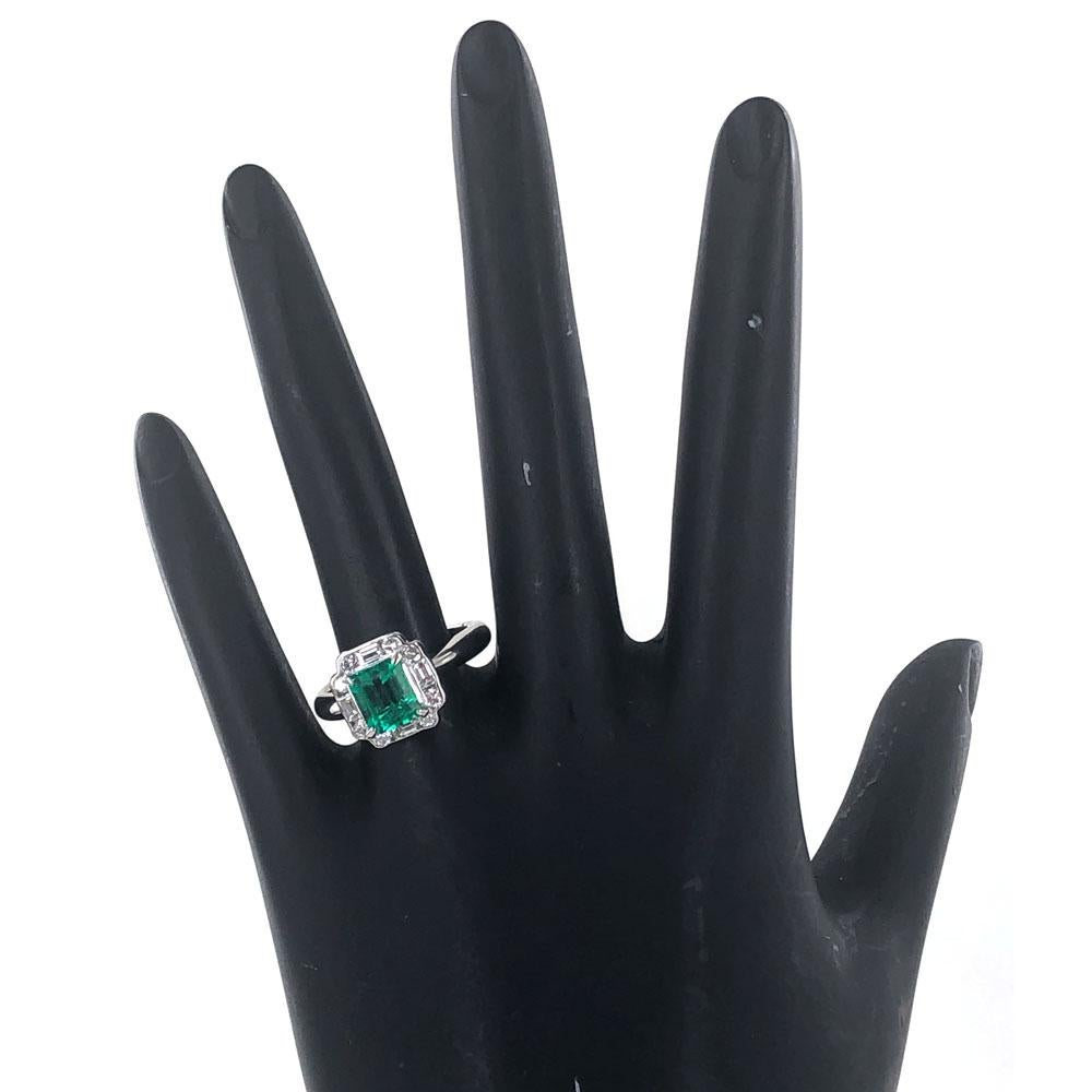 Stunning bright green Columbian emerald diamond estate ring crafted in platinum. The 1.34 carat rectangular natural green Columbian emerald is surrounded by baguette and round cut diamonds weighing .62 cart total weight. The diamonds are graded G-H