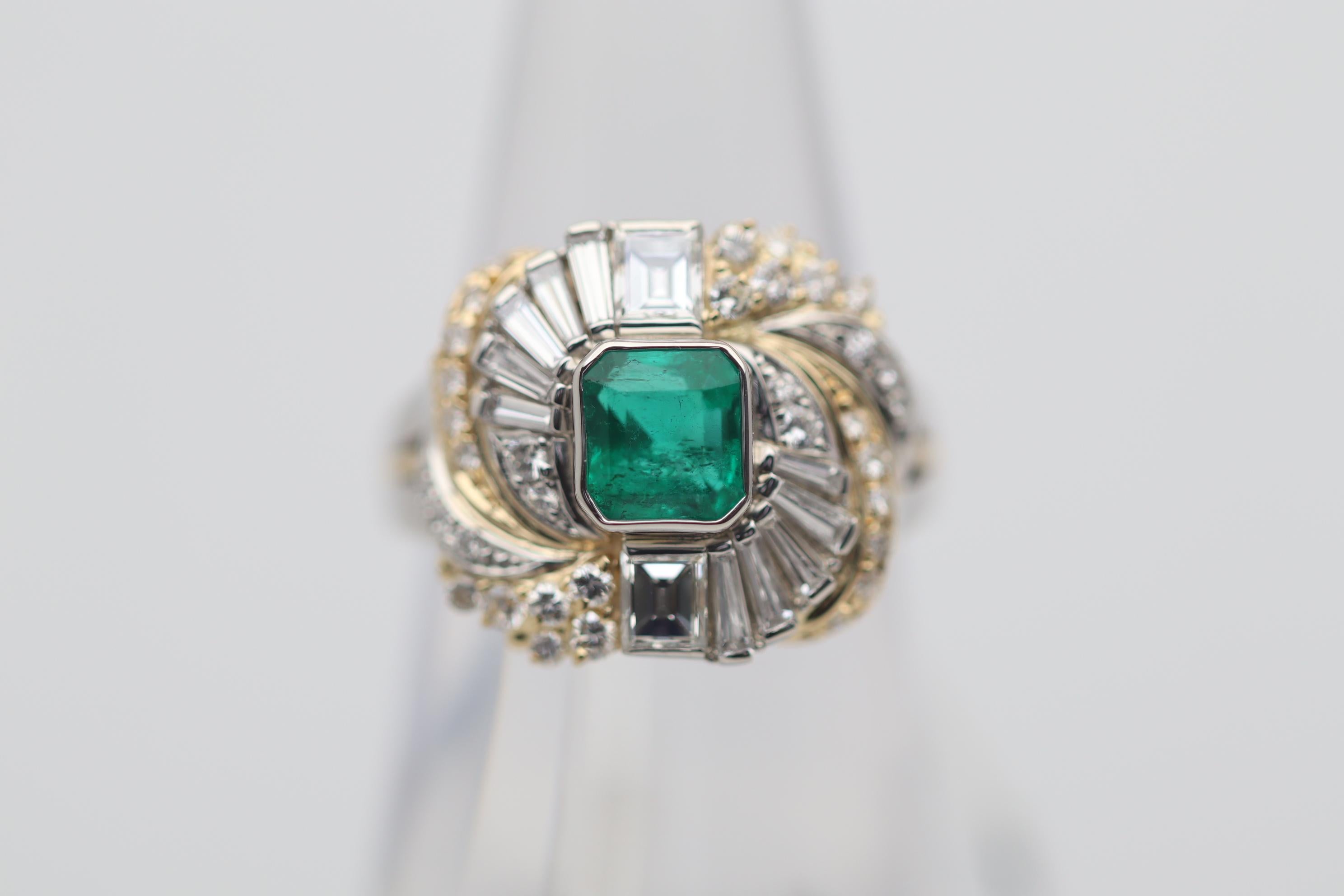 A chic and stylish ring featuring a fine gem-quality emerald in its center. The emerald weighs 0.95 carats and the ideal bright intense green color emeralds are famous for. Complementing the fine gemstone are 1.12 carats of diamonds which include