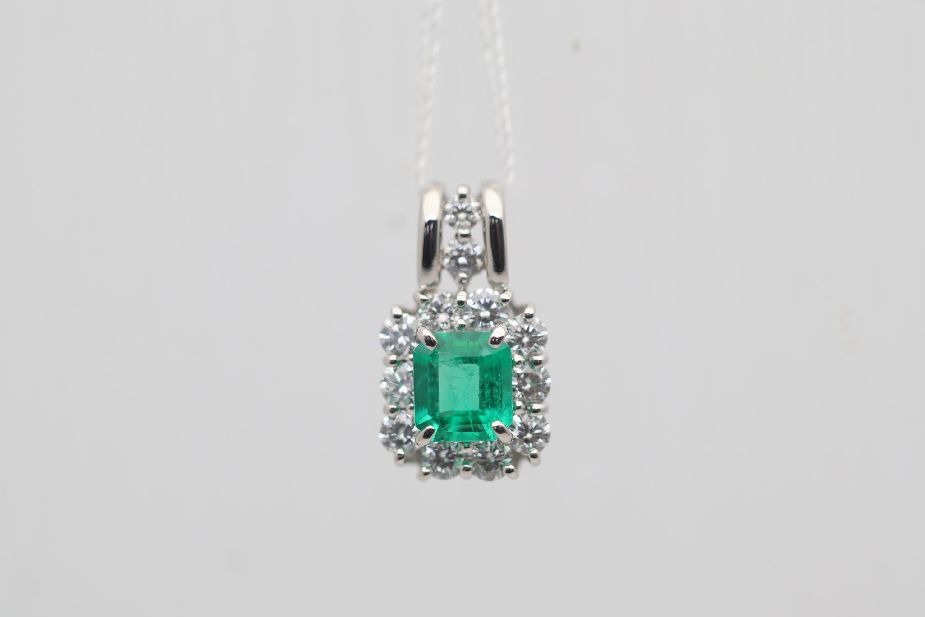 A lovely pendant with a fine gem-quality emerald in the center. The emerald weighs 0.75 carats and has a rich and bright vivid green color which is just so fine and pleasing to the eye. It is complemented by 0.72 carats of round brilliant-cut