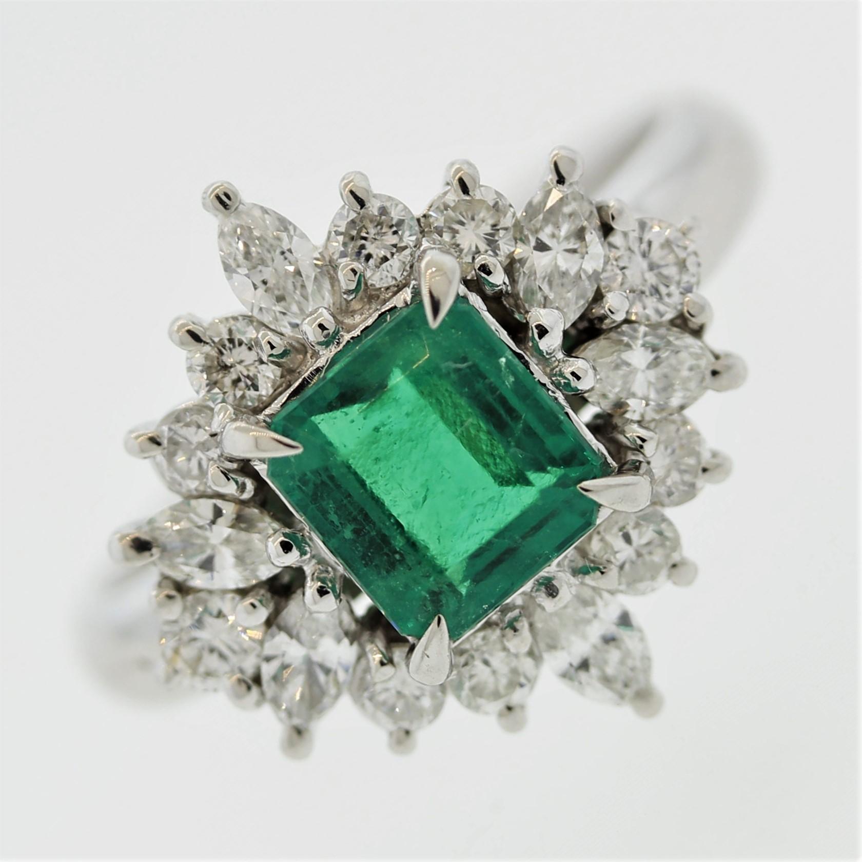 A beautiful and classy ring featuring a fine 1.13 carat emerald. It has a bright vivid green color making us believe it is from Colombia, specifically the Muzo mines. It is accented by 0.82 carats of round brilliant and marquise-cut diamonds.