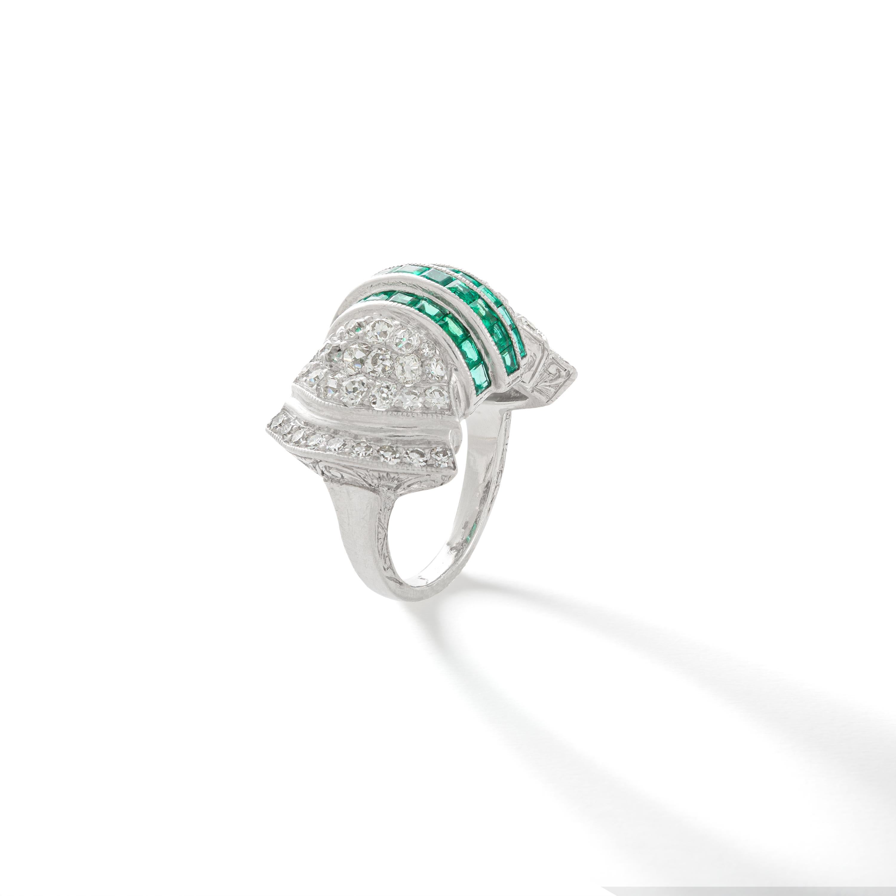 The beauty of Art Deco design is perennially fashionable. Here is the perfect proof.
Calibrated Emerald mounted on platinum shouldered by diamond. 
The sides and bottom are engraved.

Total diamond weight: approximately 2.00 carats

Ring size: 5 1/2.