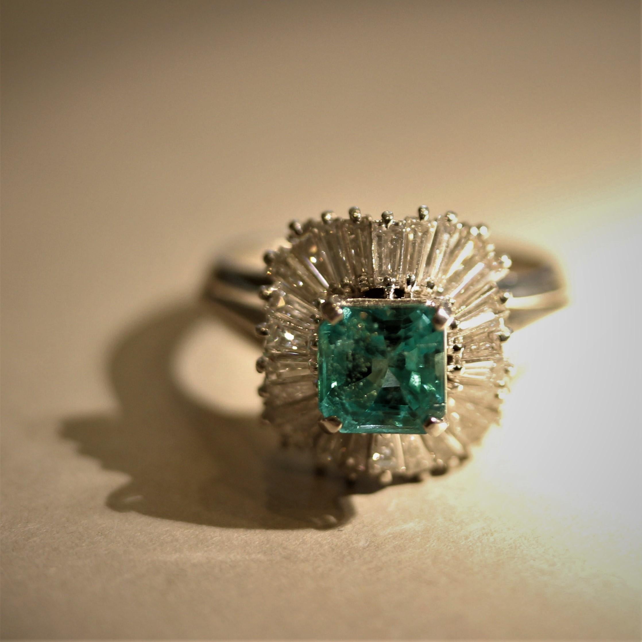 A bright and brilliant platinum gemstone ring! It features a 1.06 carat square-shaped emerald with a bright and clean green color. It is complemented by 1.17 carats of baguette-cut diamonds which are set around the emerald in a sharp sunburst