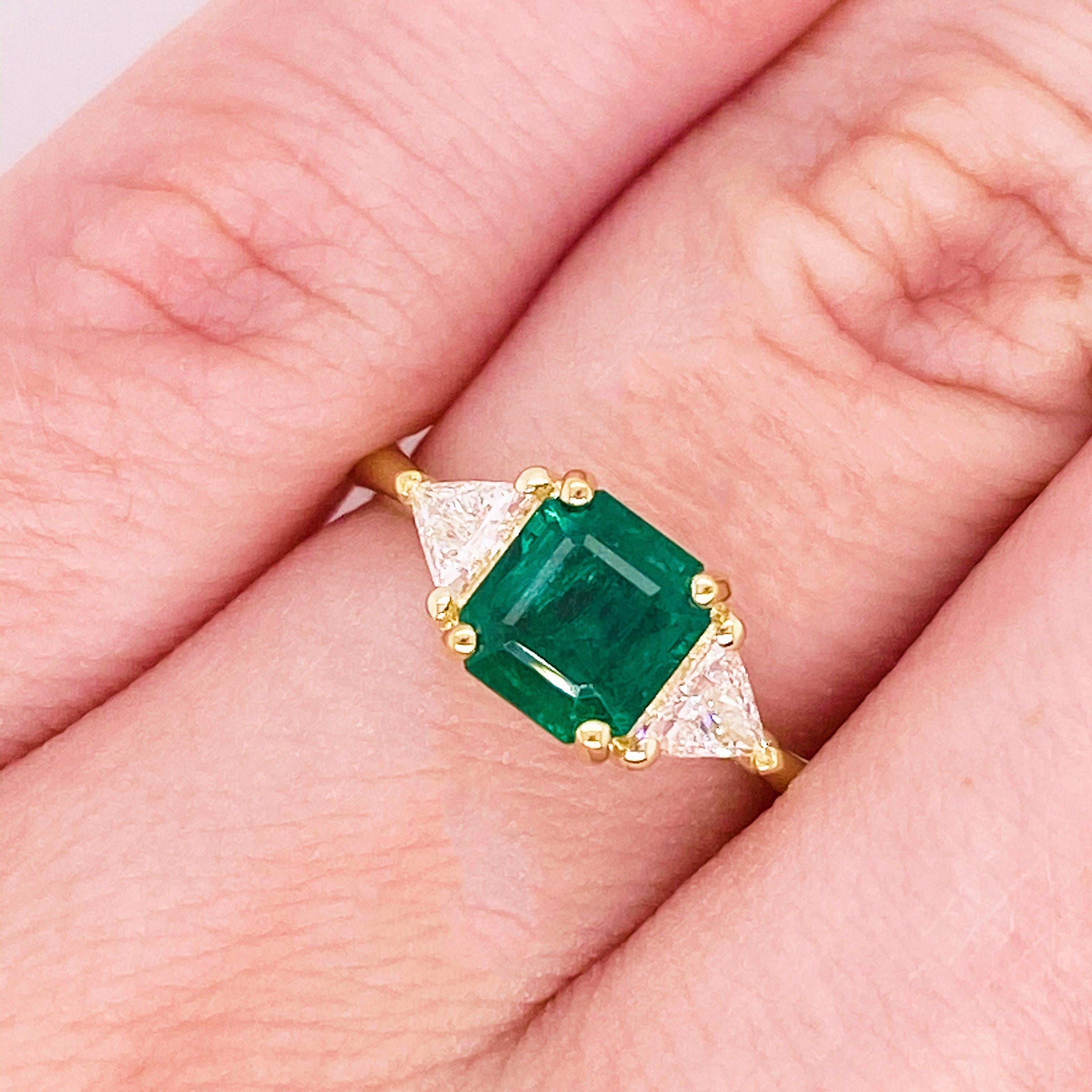 The three stone emerald and diamond ring was designed, cast, and set in our shop!  This stunningly beautiful green emerald surrounded by two gorgeous trillion diamonds set in polished 18k yellow gold provides a look that is very modern and classic