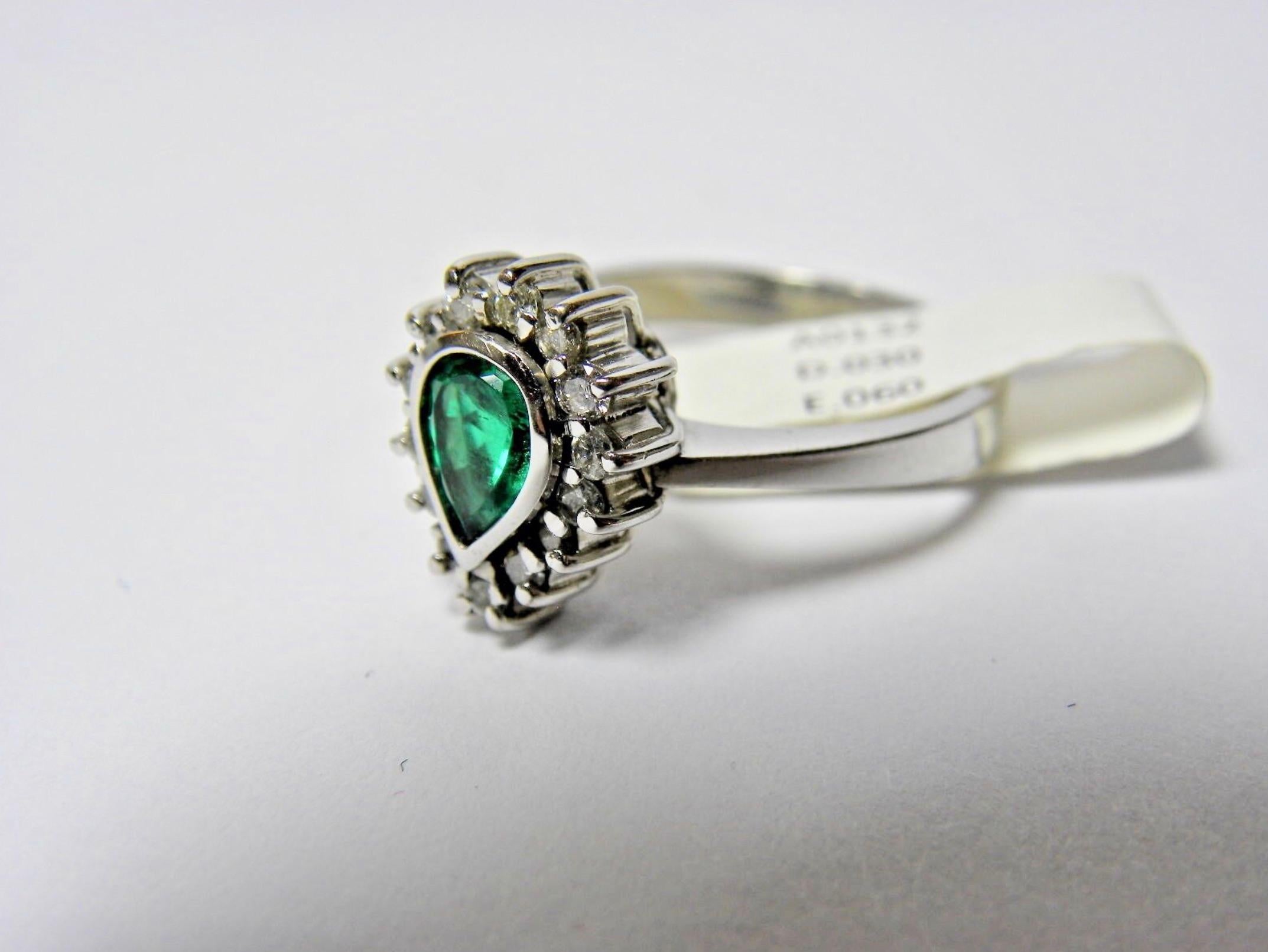 This is a beautiful and exclusive design  Emerald and Diamond Engagement Ring
Feature 1 genuine and natural HIGH QUALITY COLOMBIAN EMERALDS
Pear Cut 0.60 Carats Total Weight 
The emerald is bezel set Shimmering Perfect AAA Intense Medium Green