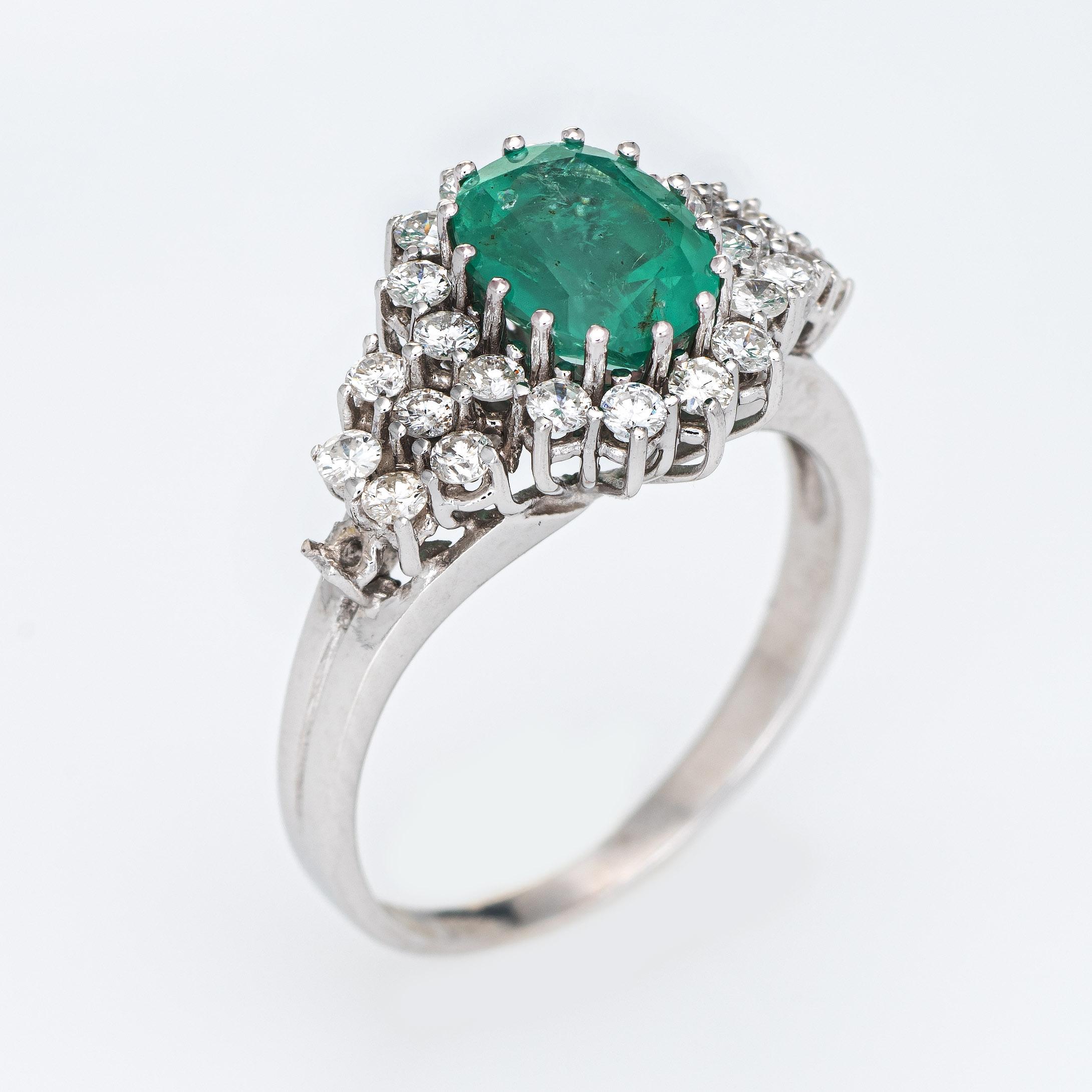 Stylish emerald & diamond ring (circa 2000s) crafted in 14k white gold. 

28 round brilliant cut diamonds total an estimated 0.78 carats (estimated at G-H color and VS2 clarity). The emerald measures 8.5mm x 6.5mm (estimated at 2 carats). The