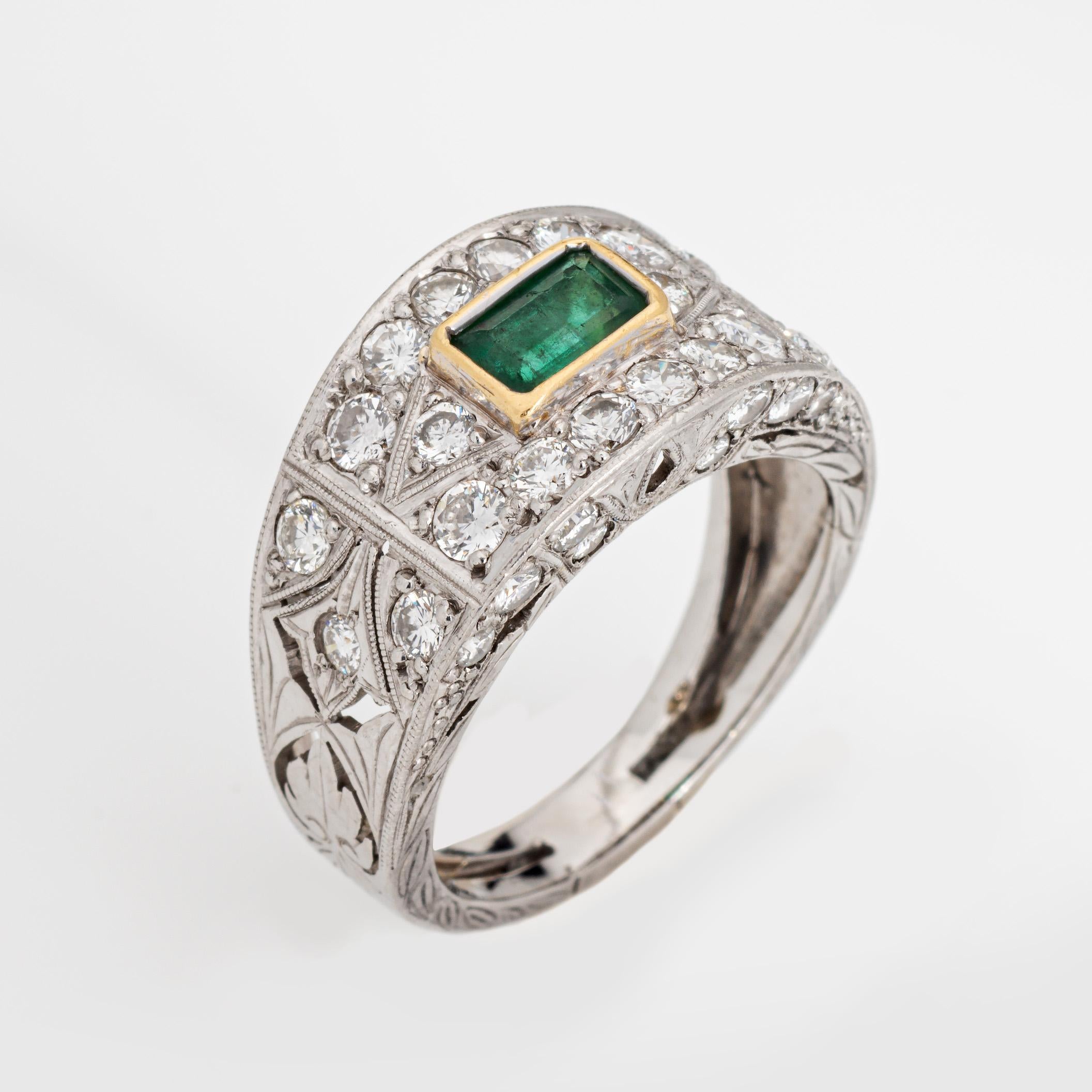 Stylish and finely detailed emerald & diamond ring crafted in 900 platinum.

Center set emerald measures 5.5mm x 4mm. Diamonds total an estimated 0.75 carats (estimated at H-I color and VS2-SI2 clarity). Note: few chips to the emerald (visible under