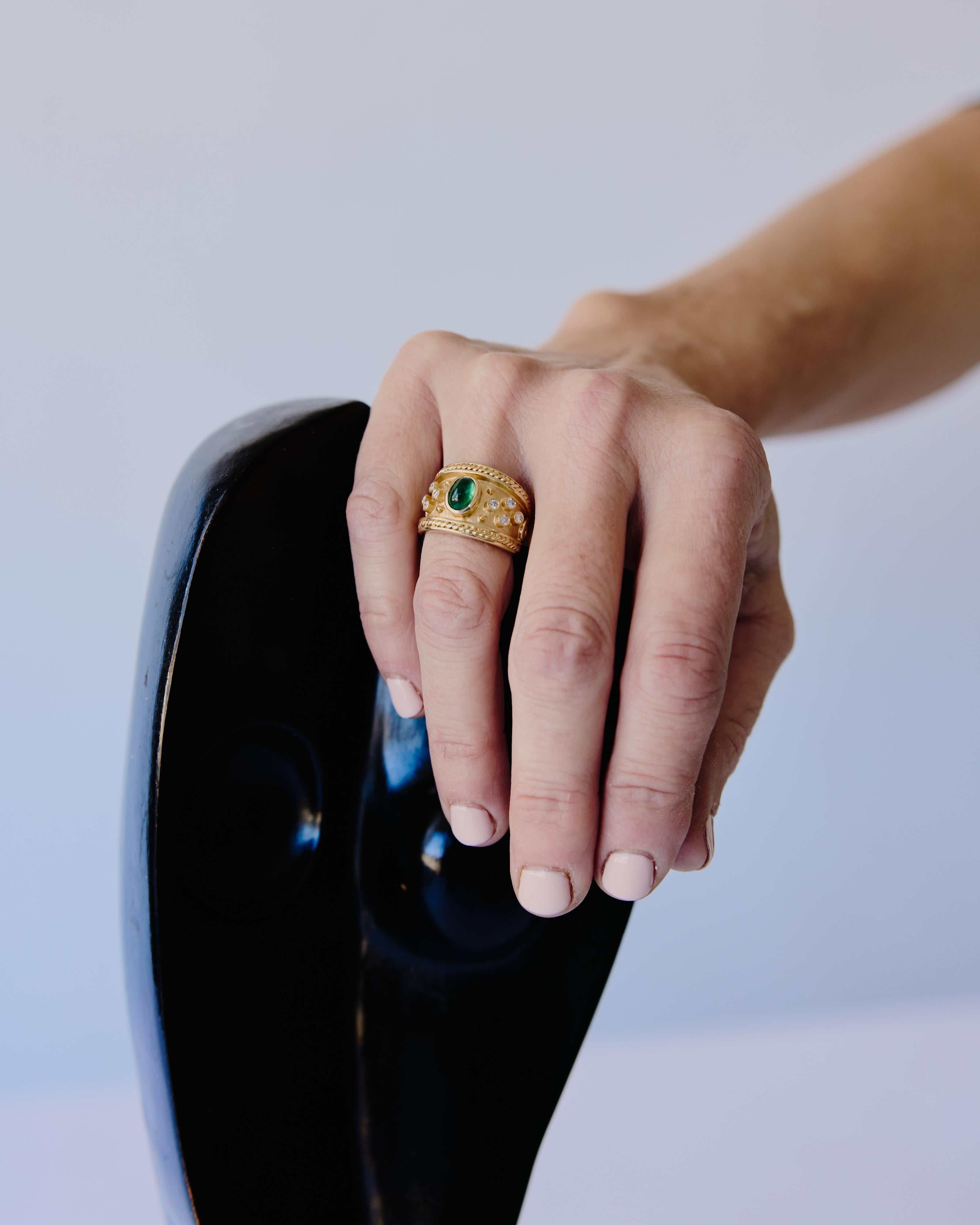 Rare, vintage ornate gold ring with an oval emerald cabochon and eight round diamonds. Stamped 14k 580 Hong Kong EA.

Material: 14k gold, emerald, diamond.

We recommend storing in a dry place and periodic polishing with a cloth.