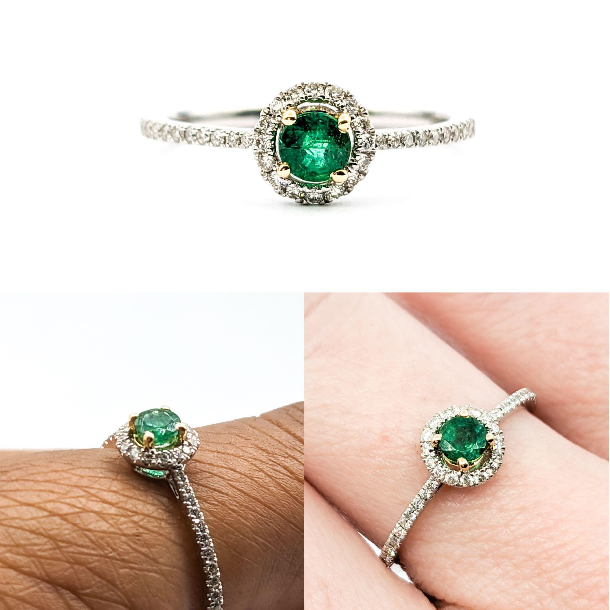 Emerald & Diamond Ring In Platinum

This exquisite emerald ring, masterfully crafted in 950 Platinum. This Ring boasts a halo of .18ctw diamonds that sparkle with SI-I clarity and a near colorless hue surrounding a stunning .22ct natural emerald