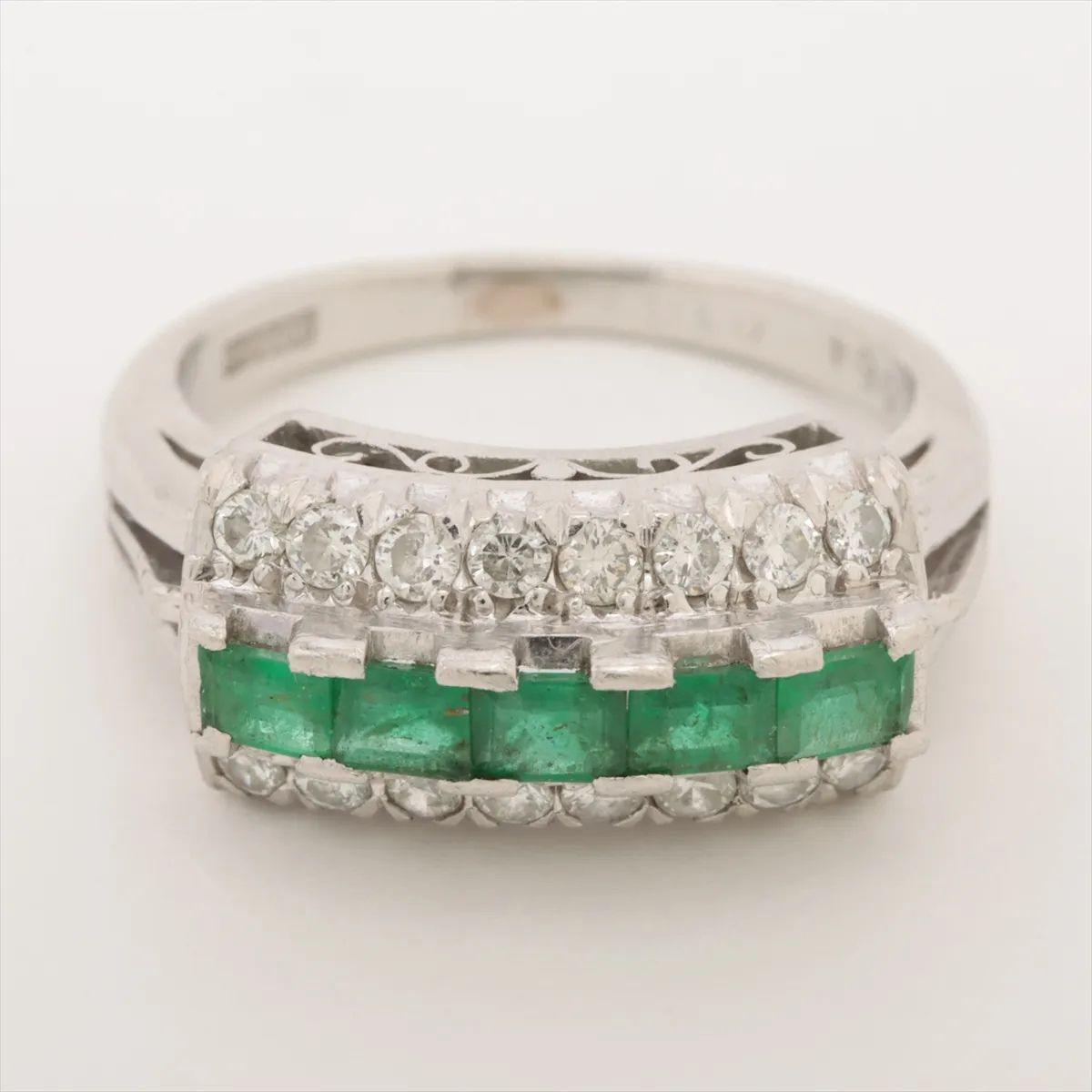 This exquisite Emerald Diamond Ring in platinum showcases a harmonious blend of vibrant color and refined brilliance. At the center, five square-cut emeralds are set side by side, their rich green hue offering a striking focal point. Flanking the