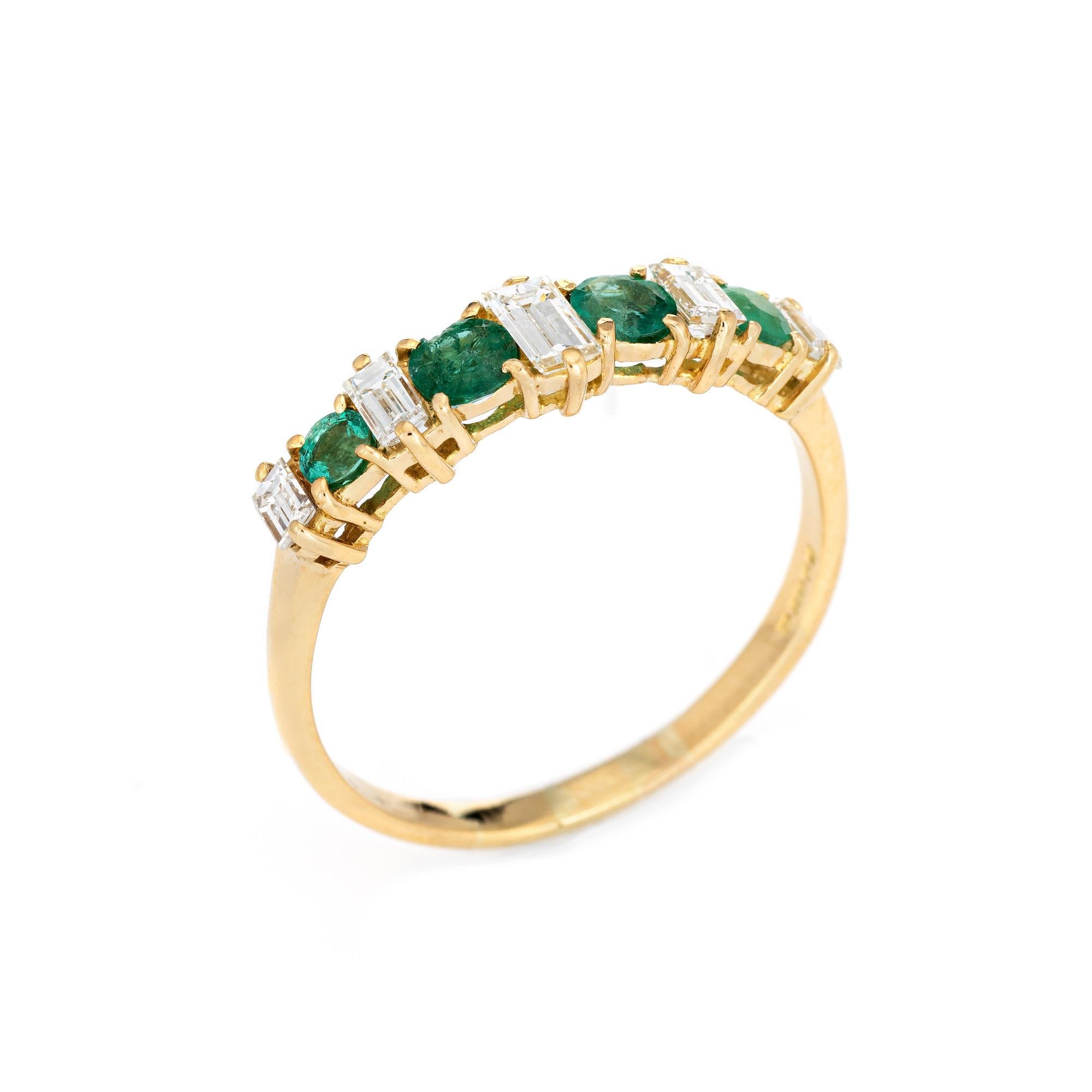 Stylish vintage emerald & diamond ring crafted in 18 karat yellow gold. 

Straight baguette cut diamonds range in size from 0.10 to 0.25 carats and total an estimated 0.75 carats (estimated at G-H color and VS1-SI1 clarity). Four emeralds total an