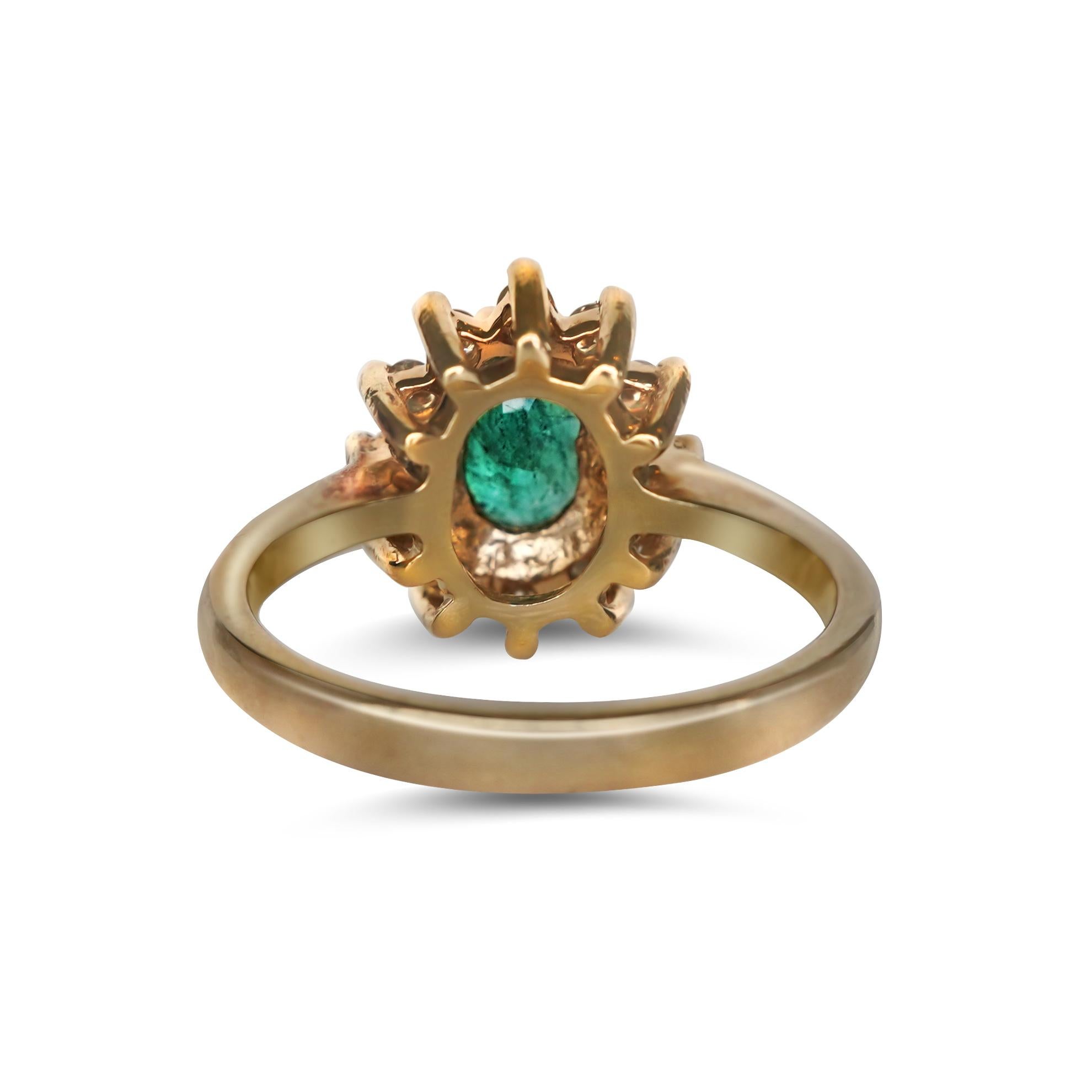 14K yellow gold ring with emerald center stone and 0.40 carat natural diamond side stones. The ring is surrounded by 12 round brilliant cut diamonds and claw set with oval cut emeralds.

Emerald dimensions: 0.50 ctw, length 6.87 mm, width 11.86