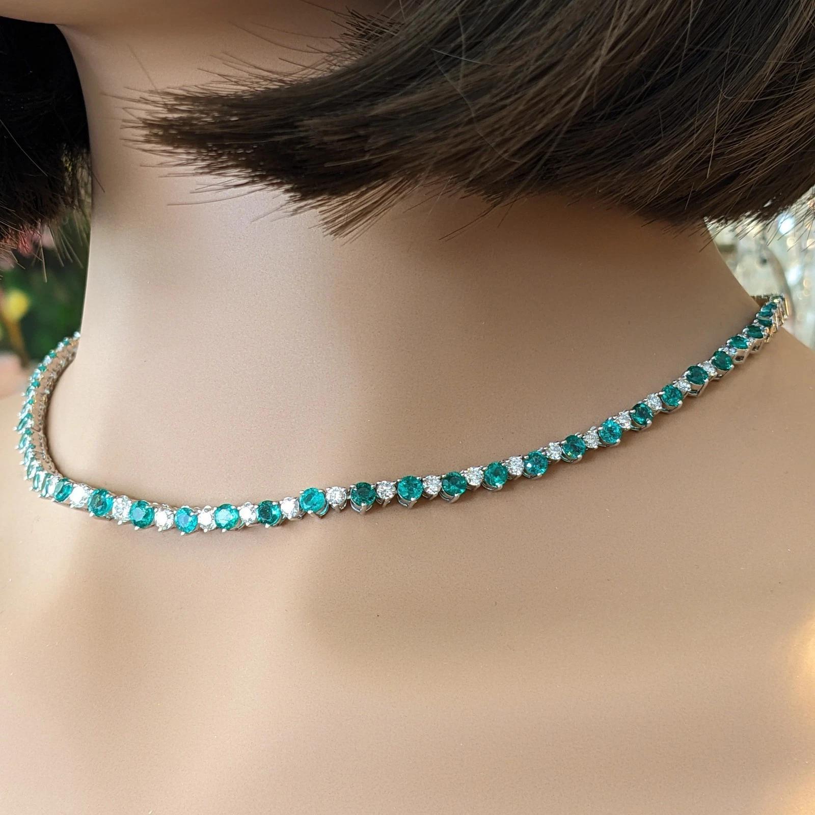 Emerald and Diamond Riviera Tennis Necklace in 14k White Gold

Emerald and Diamond Necklace features graduating Natural Round Faceted Emeralds alternating with Natural Round Brilliant Diamonds set in 3 prong setting in 14k White Gold. The necklace