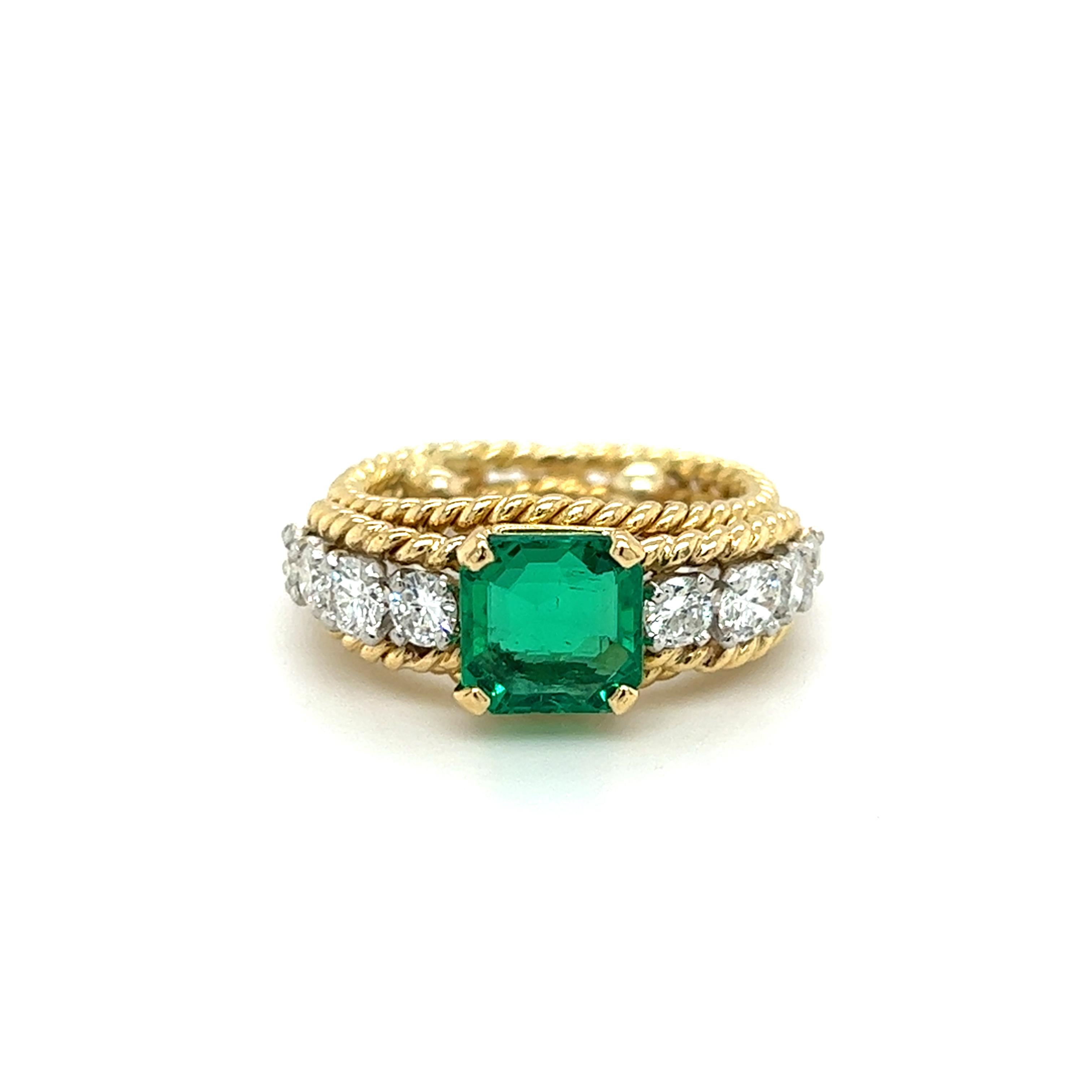 One 1970s 18 karat yellow and white gold rope style ring set with one (1) 2.77 carat square emerald cut emerald, and eight (8) round brilliant cut diamonds, approximately 0.75 carat total weight with matching H/I color and SI1 clarity. The ring