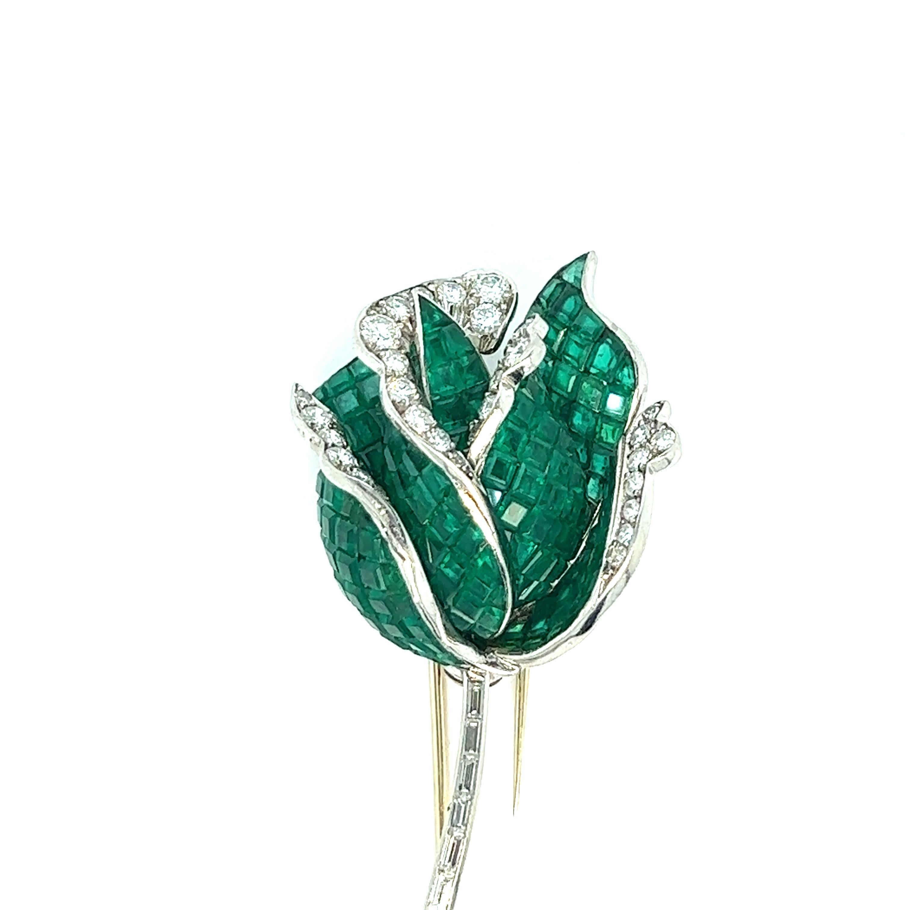 Emerald diamond rose brooch 

1950s very high quality French brooch, featuring invisible baguette-cut emeralds of approximately 35 carats and round-cut diamonds of approximately 4.5 carats set in platinum; French maker's mark

Invisible emeralds are