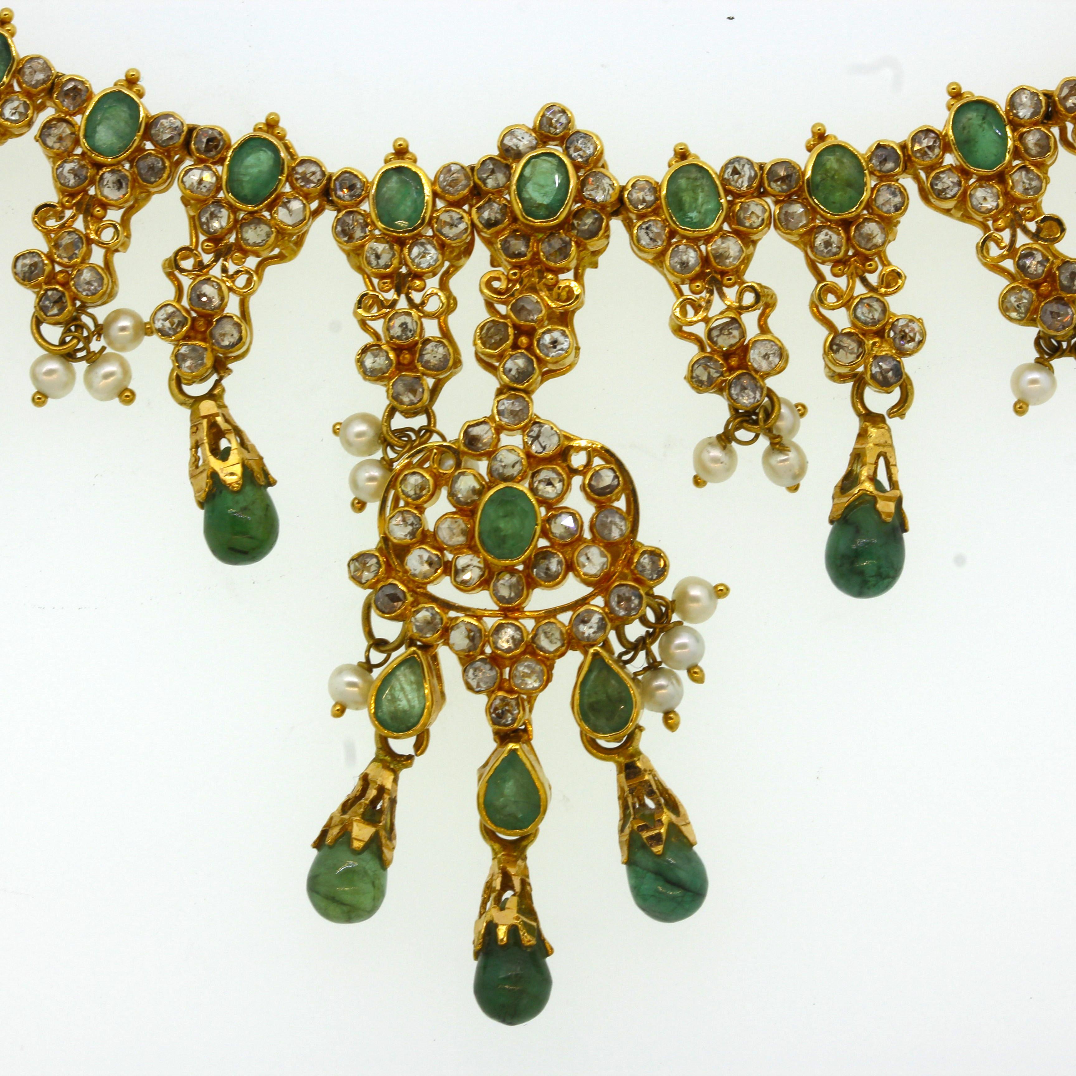A lovely decorative piece featuring faceted and cabochon emerald drops, natural seed pearls and a plethora of diamonds! They are all set in 22k yellow gold giving the necklace a bright yellow color. 

Length: 15.5 inches

Weight: 38.3 grams