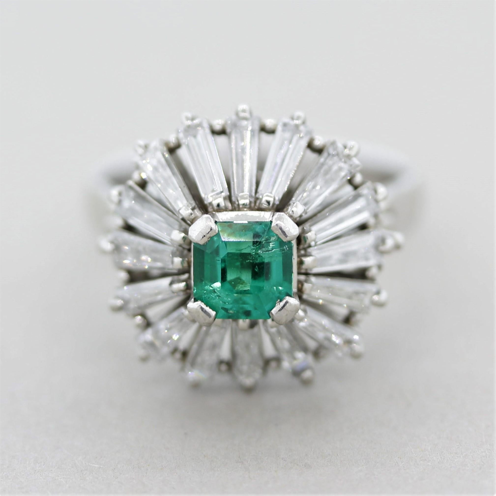 Such a fun and stylish design! This unique ring features a fine 0.67 carat square-shaped emerald with a bright green color. It is accented by 1.65 carats of long baguette-cut diamonds which radiate from the center of the ring. Hand-fabricated in