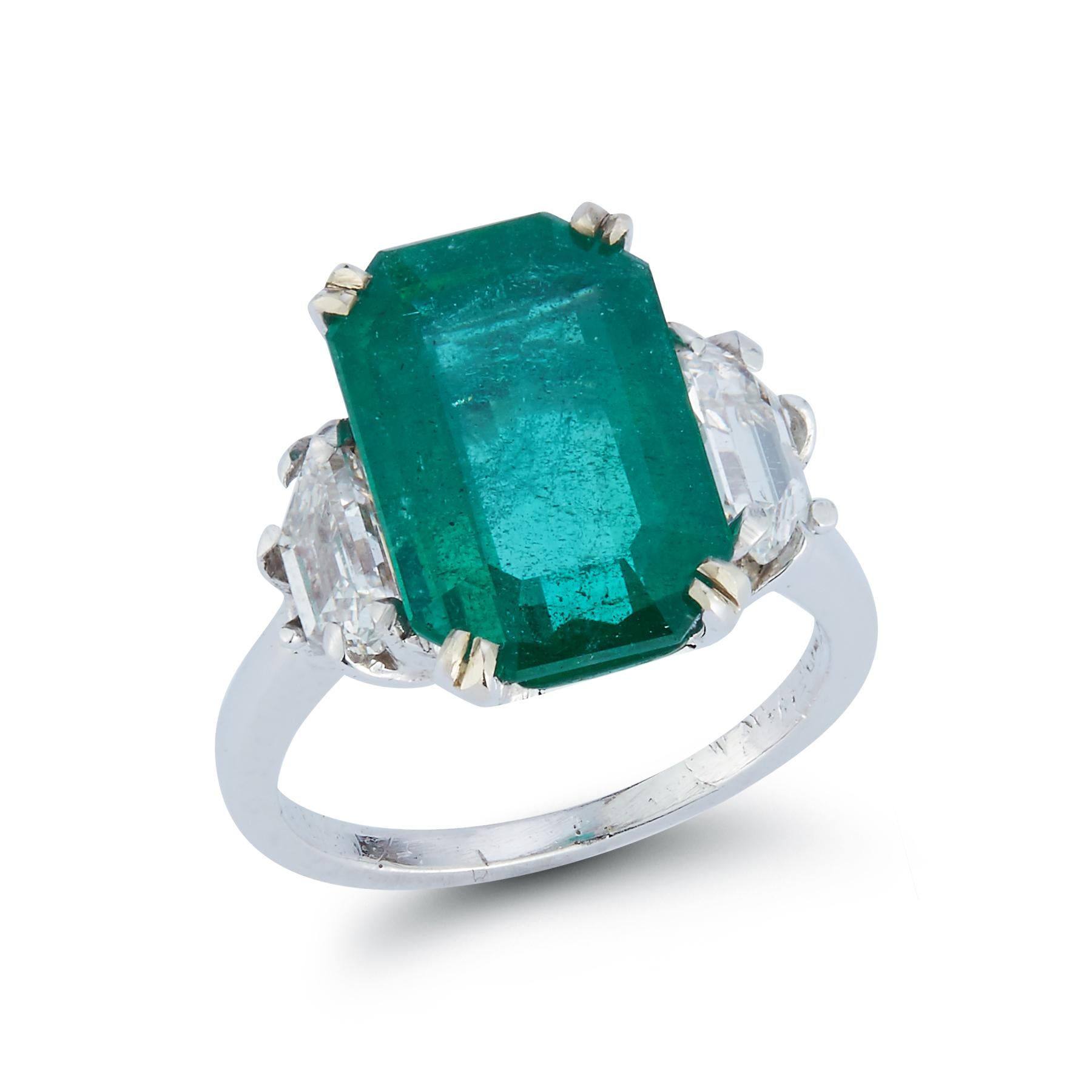 Emerald & Diamond Three Stone Cocktail Ring 

GIA Certified 

Octagonal Shape Step Cut Emerald approximately 4.15 cts with 2 Trapezoid Step-Cut Diamonds approximately .9 cts

Ring Size 3.75

Resizable Free of Charge

Gold Type: Platinum
