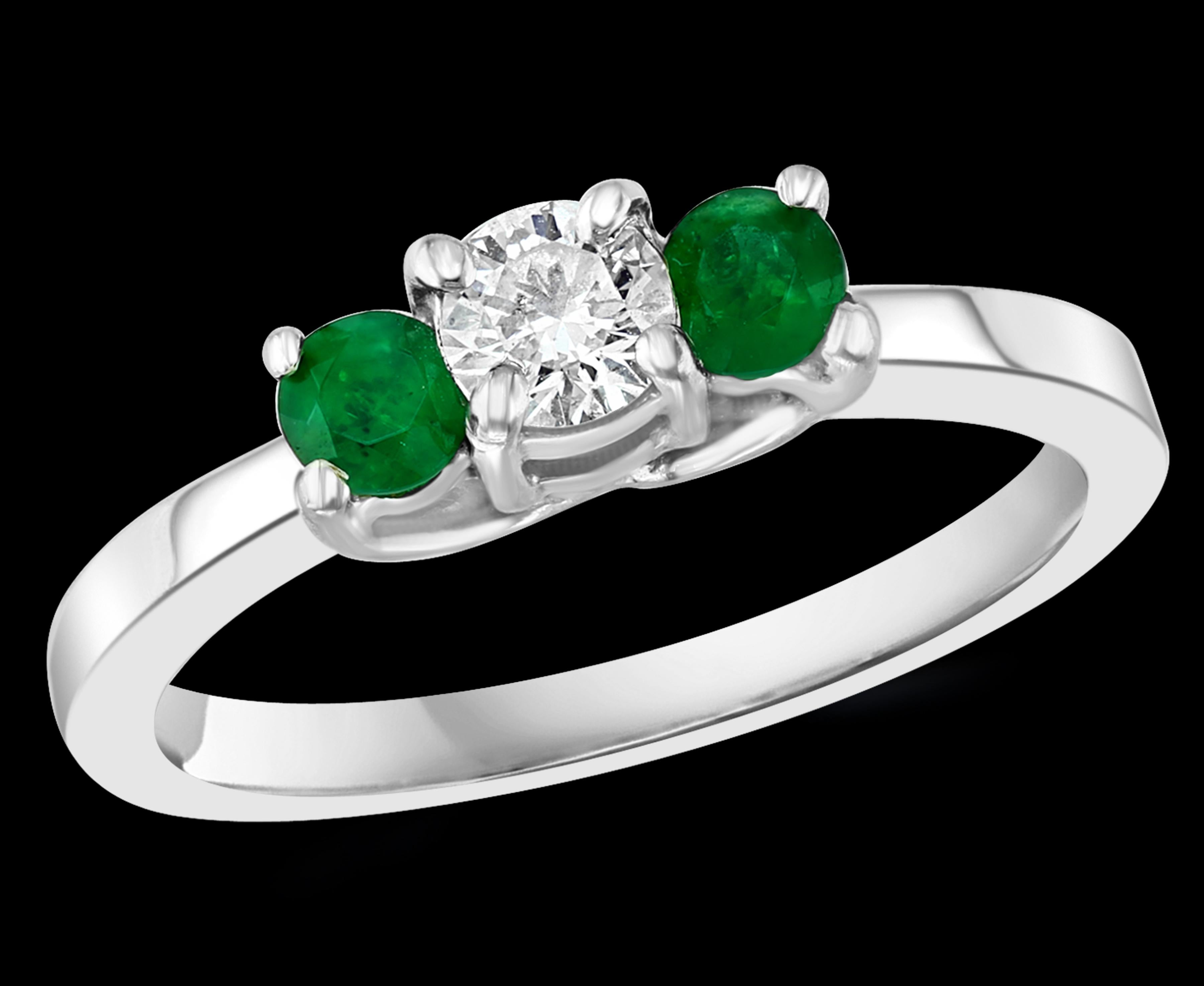 
Emerald And Diamond Three Stone Ring 14 Karat White Gold Size 6.5
Round Shape  Emerald Ring 
 Very clean and intense green color . 10 pointer each emerald . There is a 20 pointer diamond in the center
Total diamonds 0.20 Ct
Very high quality ring
