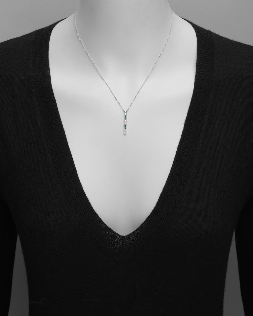 Gem-set vertical bar pendant, showcasing a series of three round brilliant-cut diamonds alternating with three princess-cut emeralds, the stones channel-set in 14k white gold and suspended from the matching 17