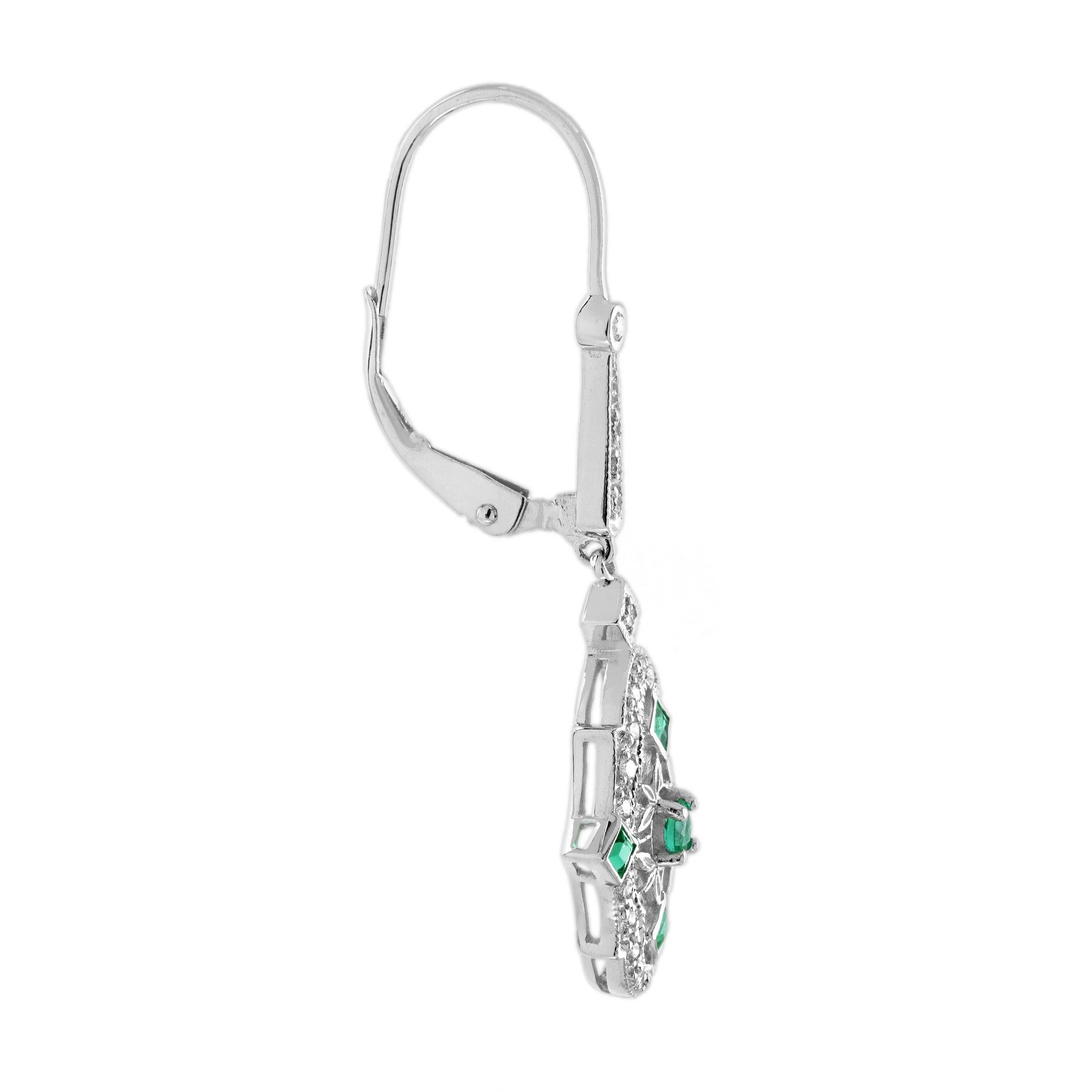 The exquisite filigree design showcases intricate floral and leaf motifs, beautifully capturing the essence of the Art Deco era. Each earring features sparkling emeralds, expertly complemented by shimmering diamonds, creating a timeless piece that