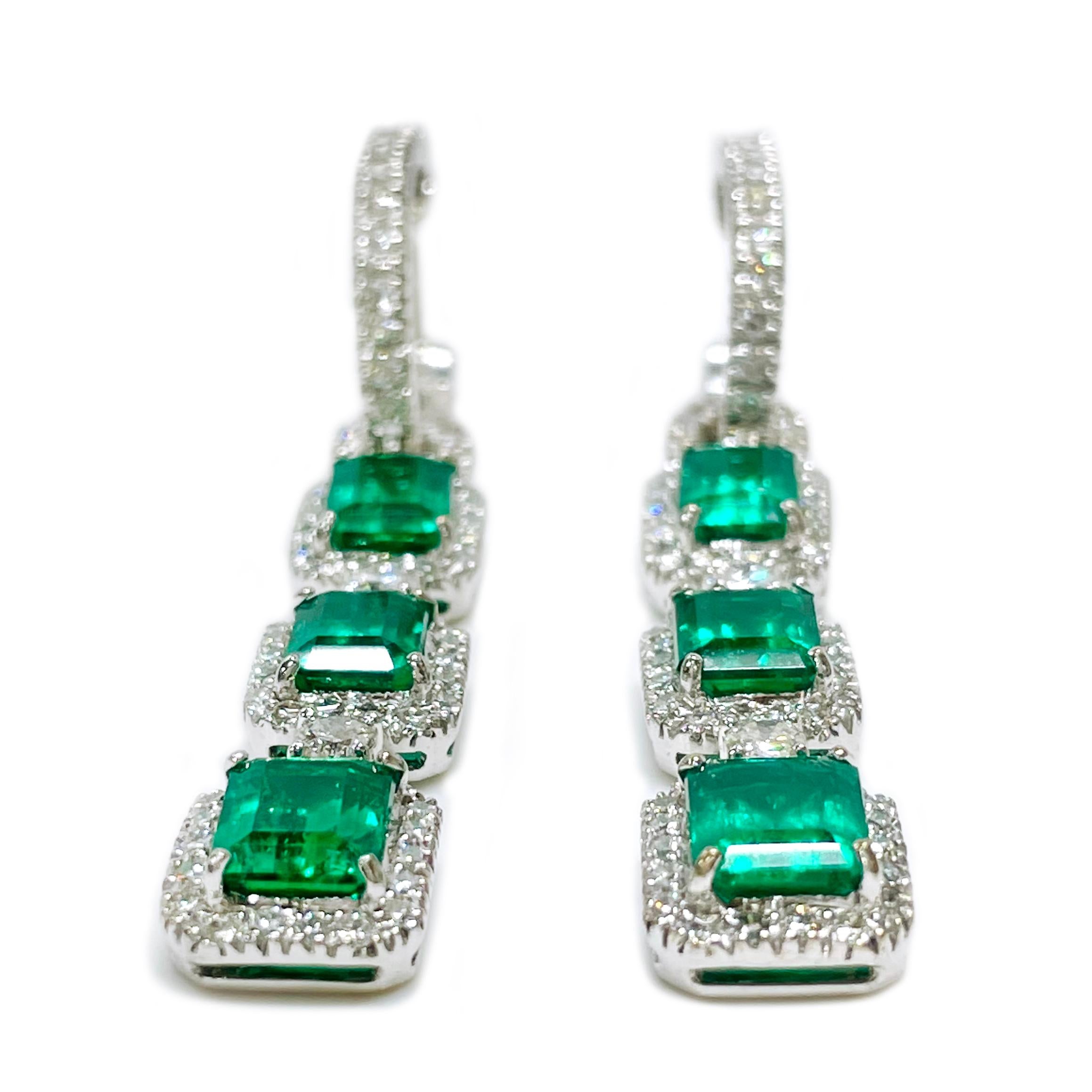 Each lever-back earring measures 55mm in height x 8.2mm in width and 4.8mm in depth.

One pair of electronically tested 18KT white gold ladies cast & assembled emerald and diamond dangle earrings. Condition is good.

Each two inch length earring