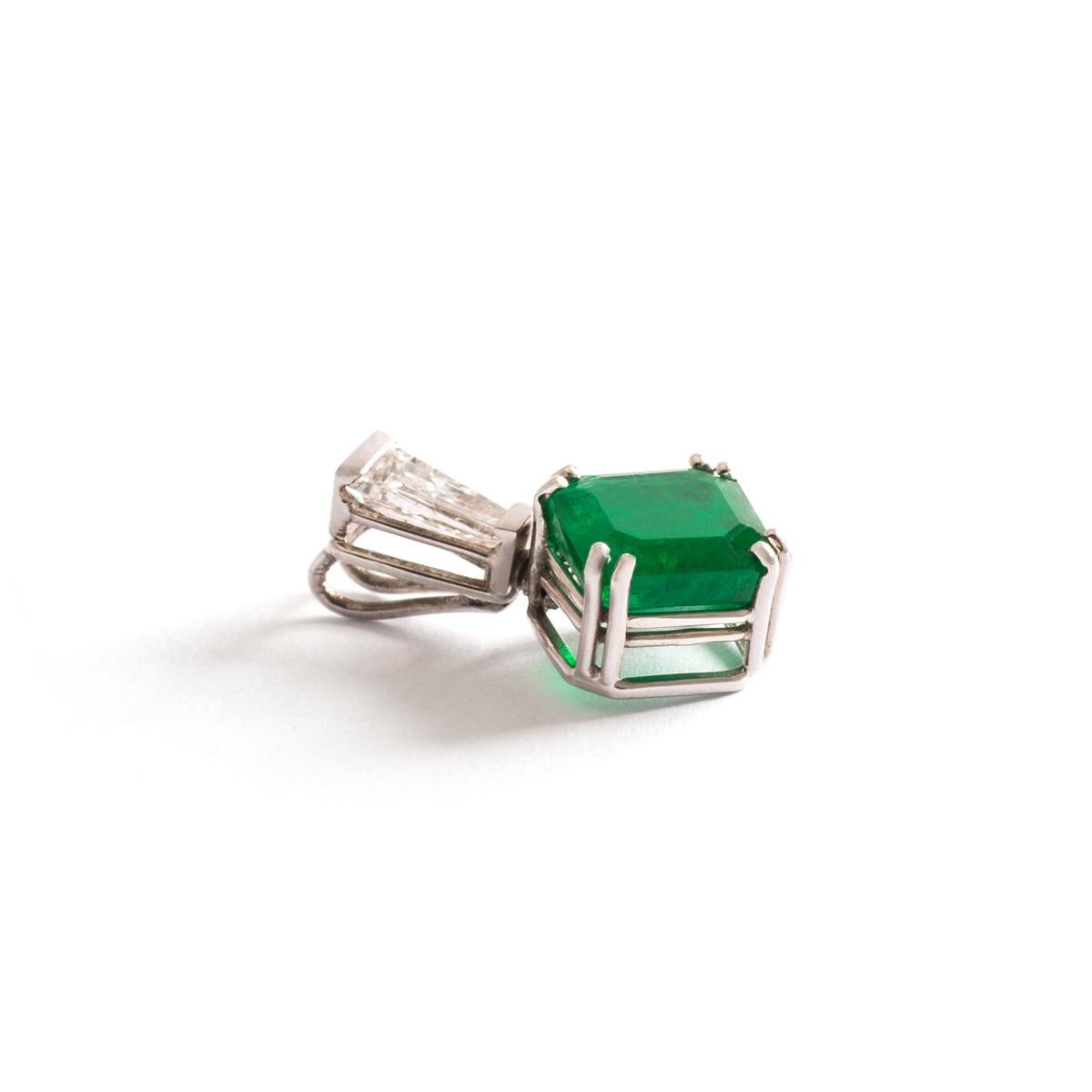 Emerald Diamond White Gold Pendant.
Emerald size: 6.09 x 5.41 millimeters.
Length: 1.50 centimeter.
Width: 0.90 centimeter.
Gross weight: 0.97 grams