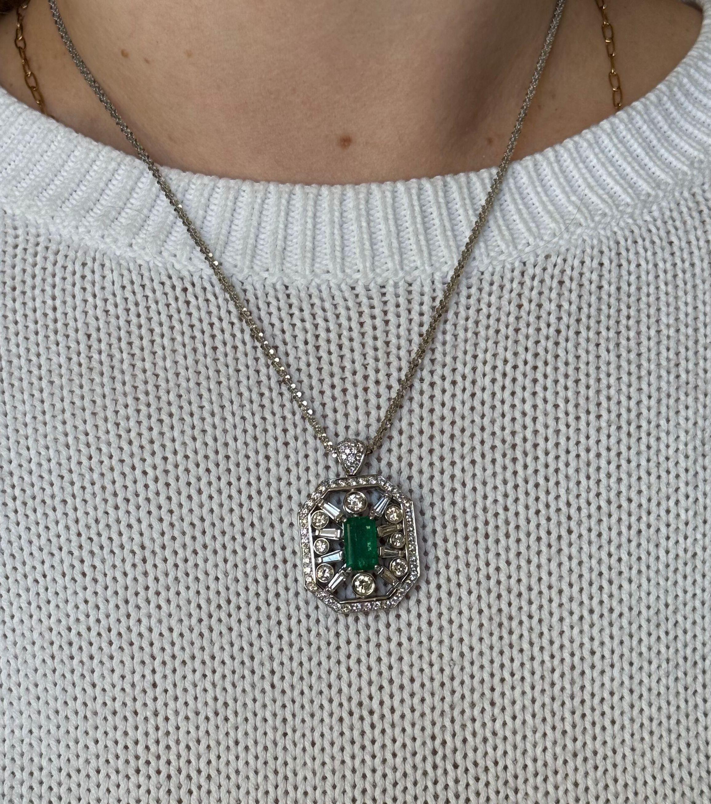 An 18k white gold pendant on a chain necklace, featuring approx. 1.90ct emerald ( measures 11.3 x 6.8 x 3.5mm) surrounded with approx. 2.55ctw in H/Si1 diamonds.
Necklace is 20