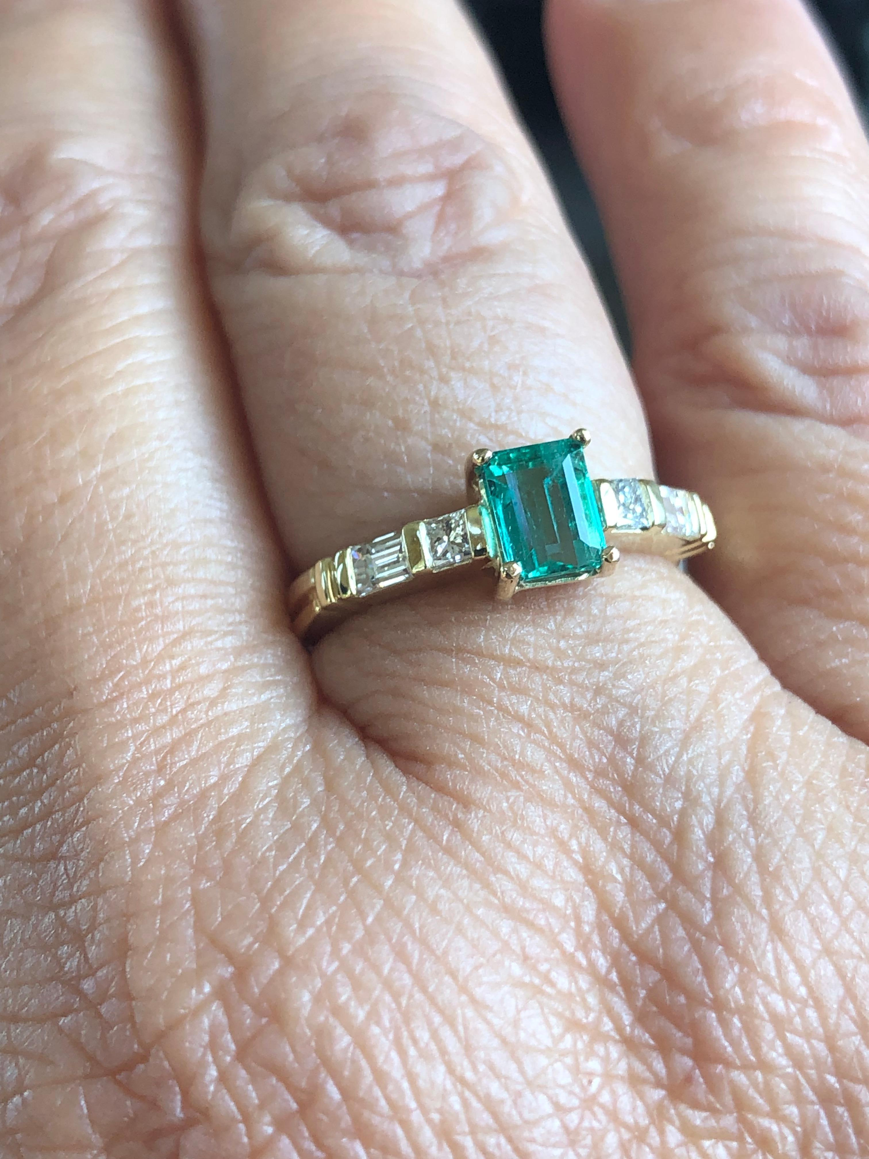 The classic engagement ring is centered with a natural emerald-cut emerald from high-quality Colombia with vibrant medium AAA+ green color, VS in clarity, weighing 0.77 carats, and four diamonds weighing 0.25-carat G-VS. Total ring weight 4.12g made