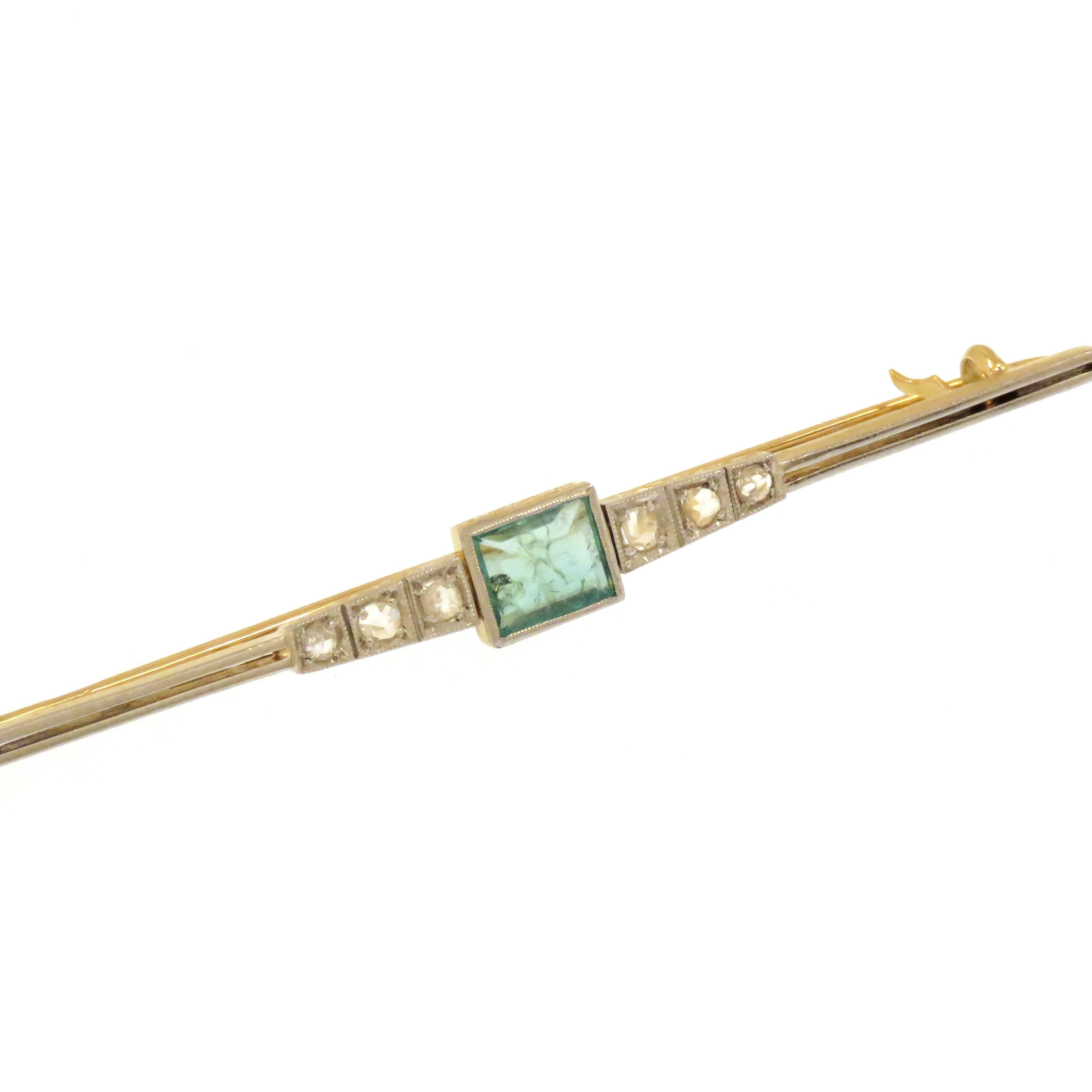 Elegant vintage brooch dating back to the 1940s crafted in 18 karat yellow and white gold. It features 6 rose-cut white diamonds and one green emerald. The size of the brooch is 68X6 mm / 2.667x0.236 inches. Marked with the Gold Mark