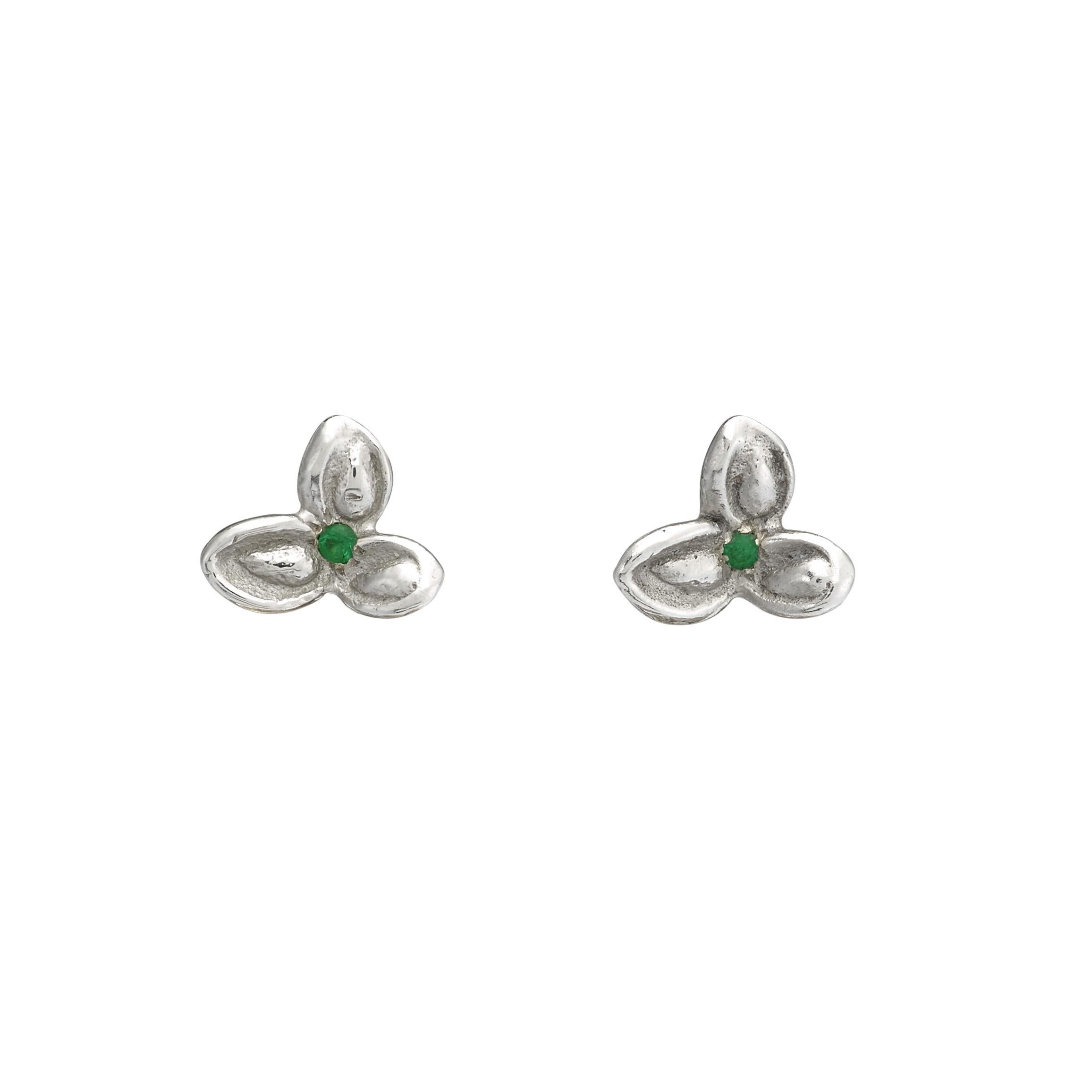 These Anais Rheiner handcrafted pair of 18 karat white gold earrings weigh approximately 4 grams. The flowers are set with emeralds and the fan-shaped part are set with white diamonds, yellow diamonds and pink sapphires. Butterfly fastening for