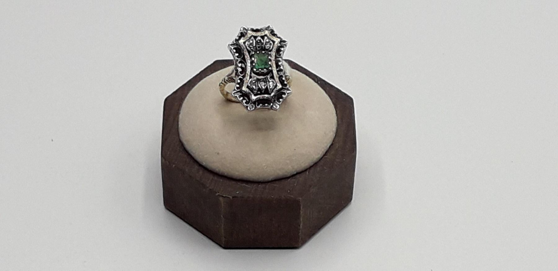 Silver and Gold ring with central emerald surrounded by small diamonds. Ring size Italian 11 please see the conversion in the table in the picture. This beautiful ring of Italian luxury jewelry 1980s is perfect for a refined and elegant woman. 
