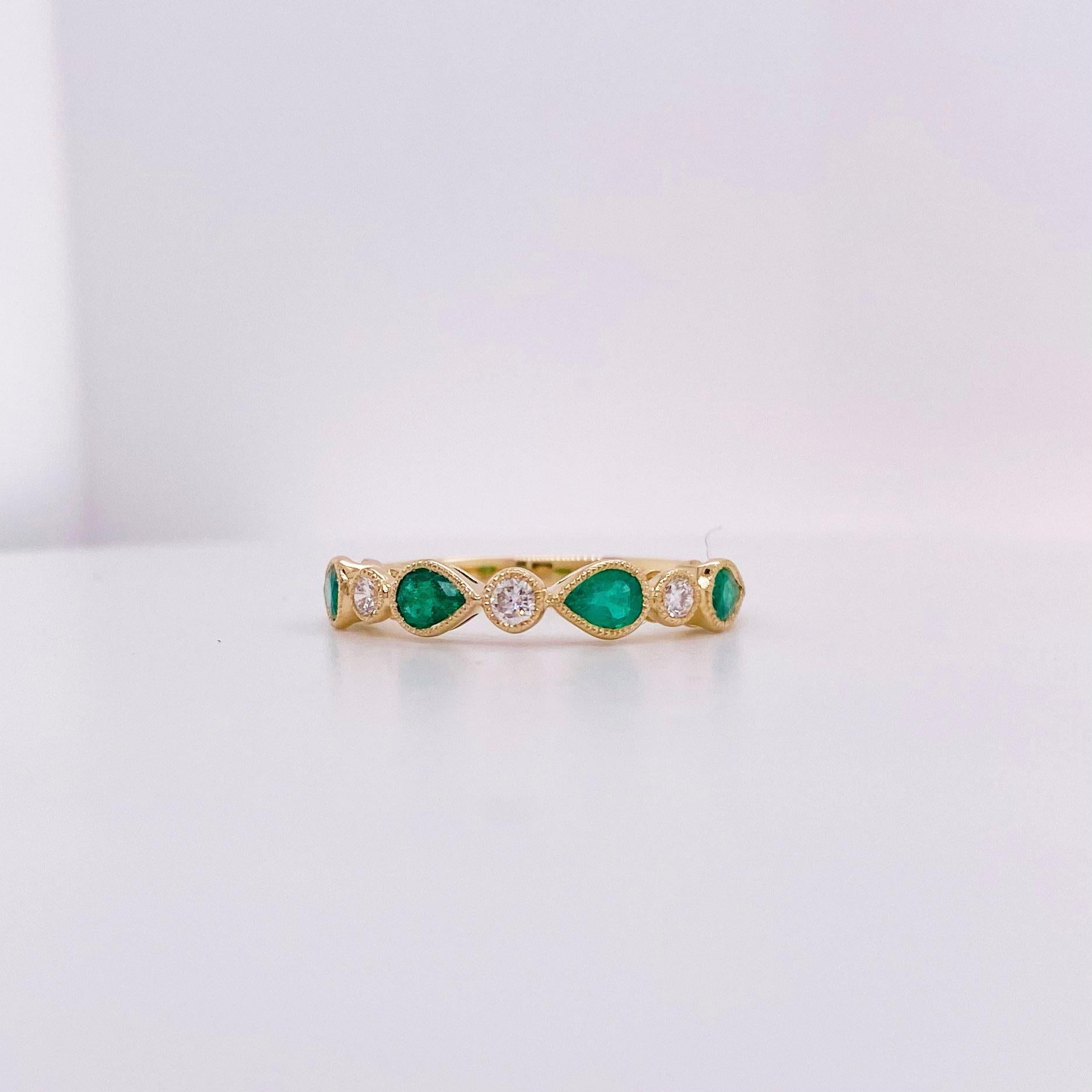 This gorgeous emerald and diamond band ring has four pear shaped emeralds and three round diamonds! There is a total of .70 carats of  natural genuine gemstones. The emeralds in this ring are so vibrrant and definitely of higher quality! The details