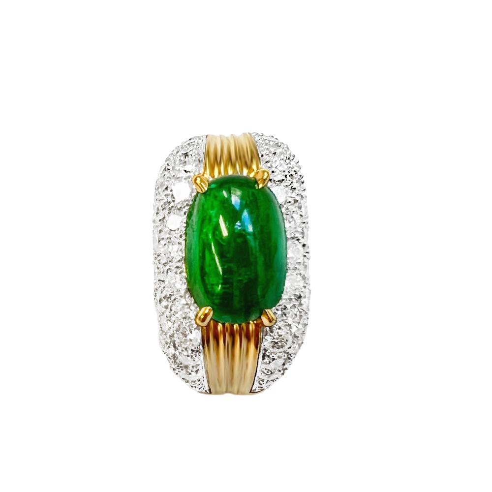 A 1.89ct Cabochon Emerald is set in the centre of this 18K yellow gold and platinum ring, and 1.08ct F Color, VS Clarity Natural Diamonds are pave-set around the dome. The emerald is mounted in gold prongs with gold ribs on each side.