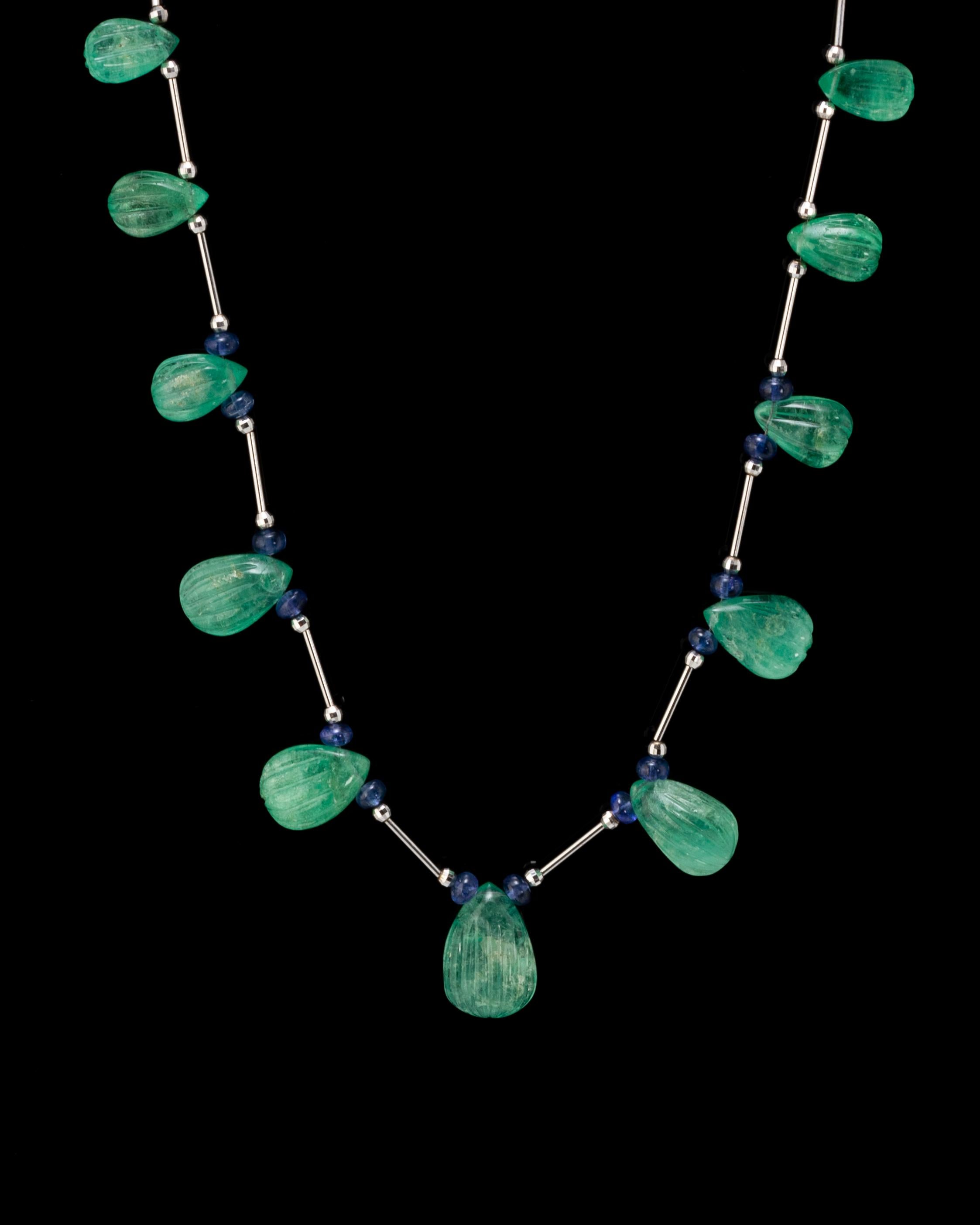 This special piece will never go out of style and will make you feel more gorgeous. From the boardroom to the ballroom, this necklace will make heads turn! 
This necklace is around 21 inches long. 

Stone Details: 
Emerald Carving Drop: 75.32